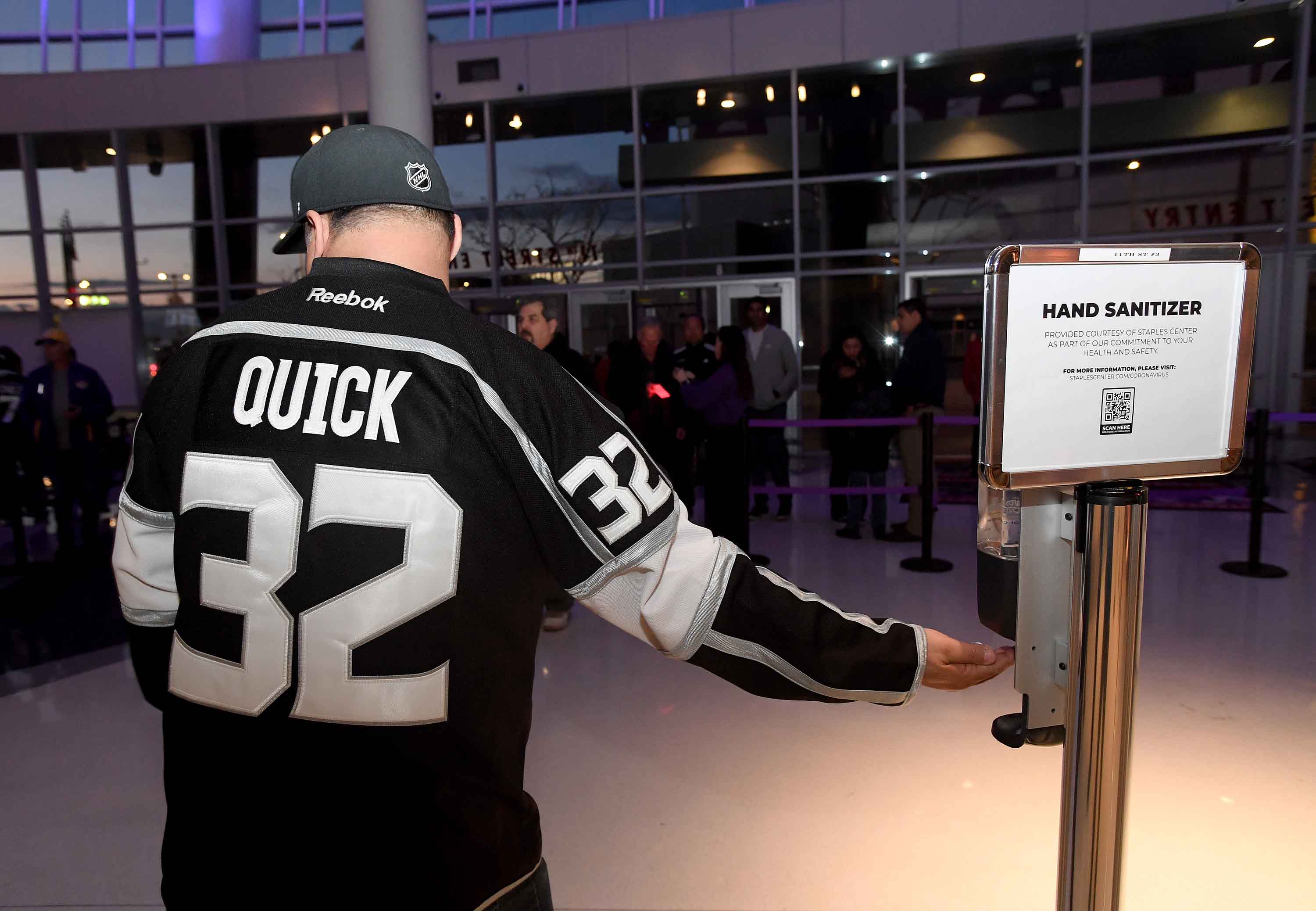 A Los Angeles Kings fan reaches for hand sanitizer before a game against the Ottawa Senators at Staples Center in Los Angeles, California, on March 11.