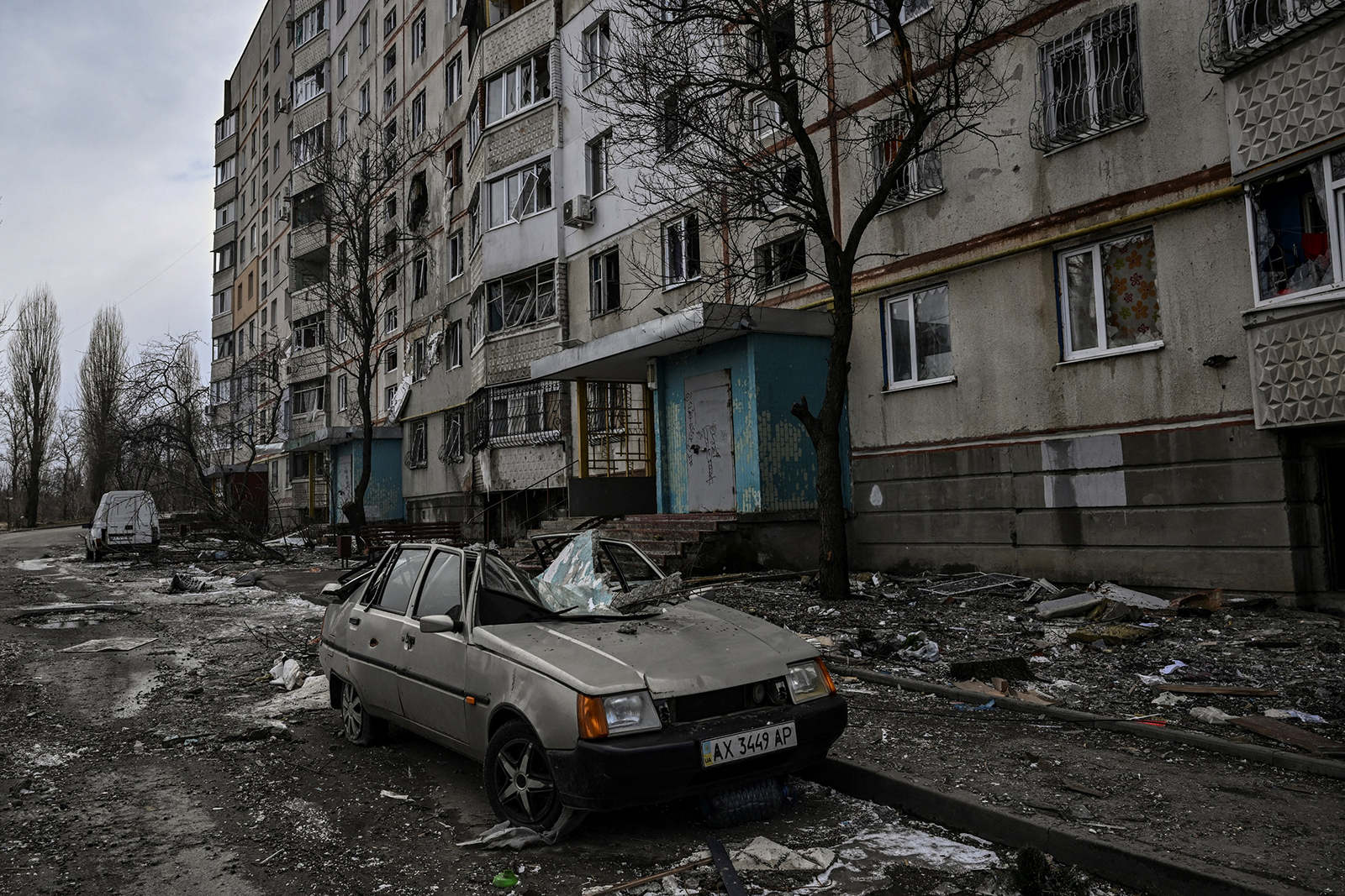 A destroyed car is seen near a damaged apartment building in Kharkiv on March 27.