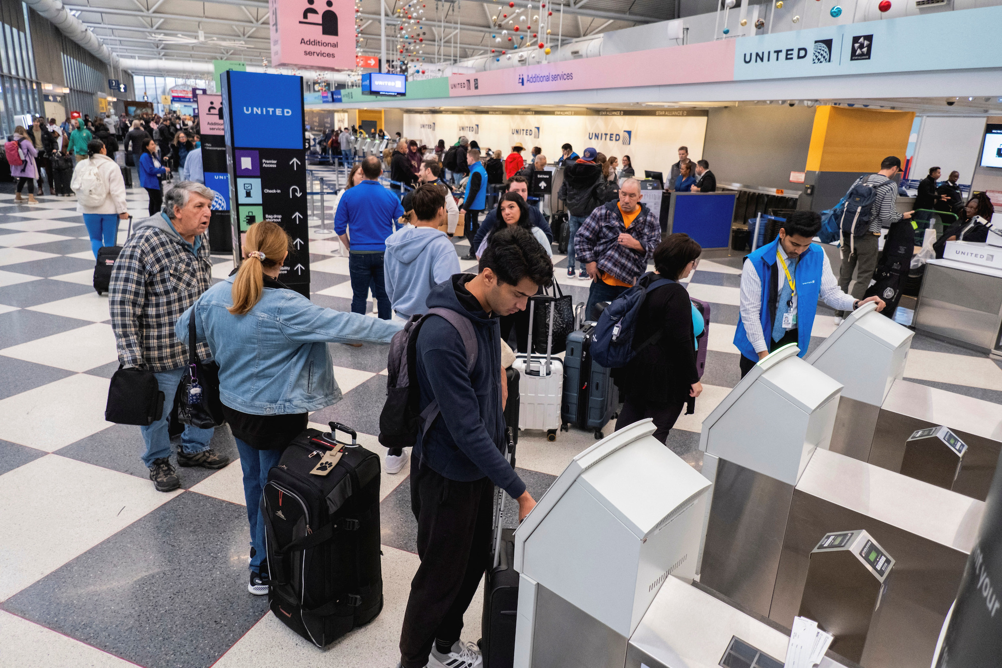 Travelers check in for flights ahead of the Thanksgiving at O’Hare International Airport in Chicago on Wednesday.