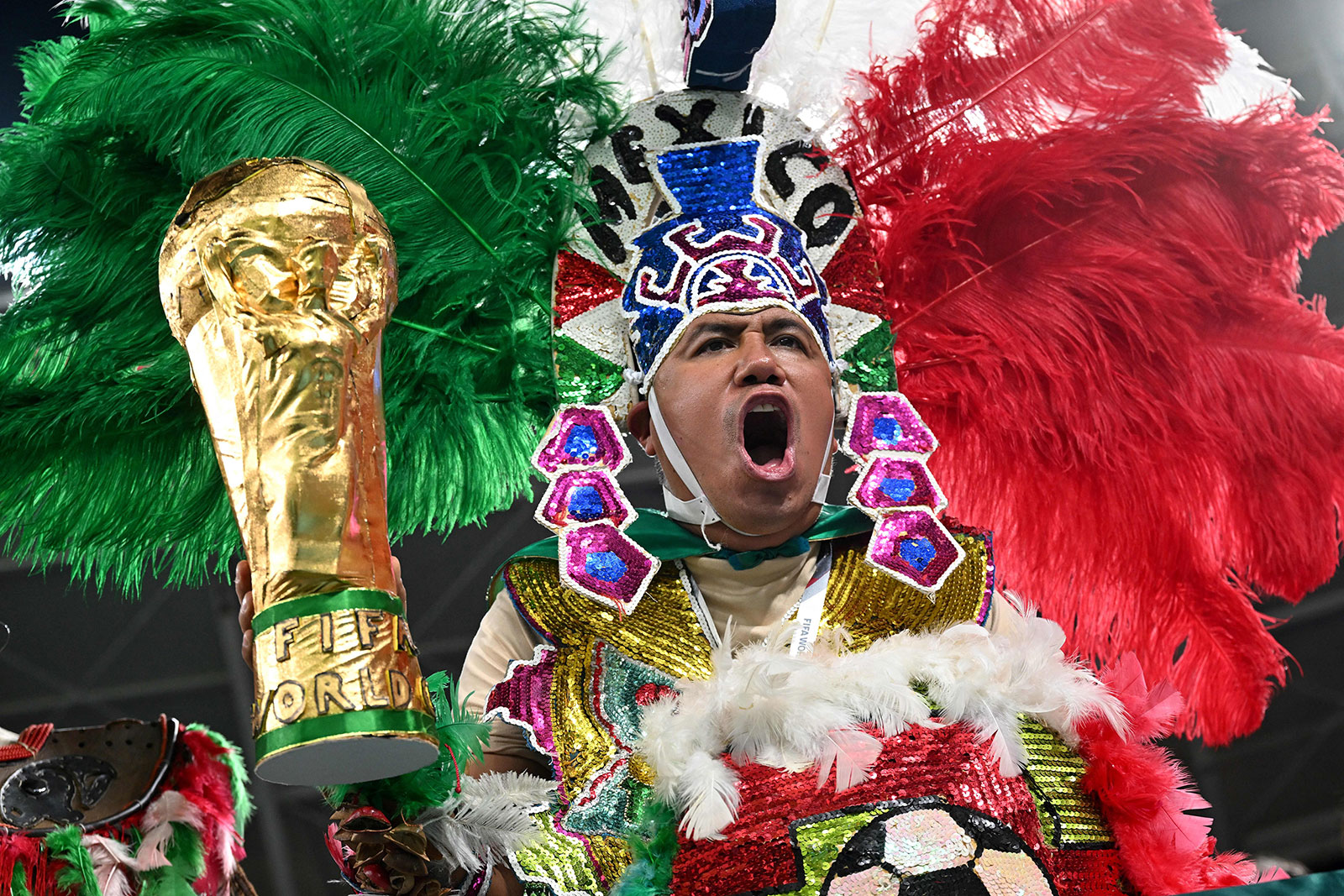 A Mexico fan cheers while holding a replica of the World Cup trophy ahead of the match between Mexico and Poland on November 22. 