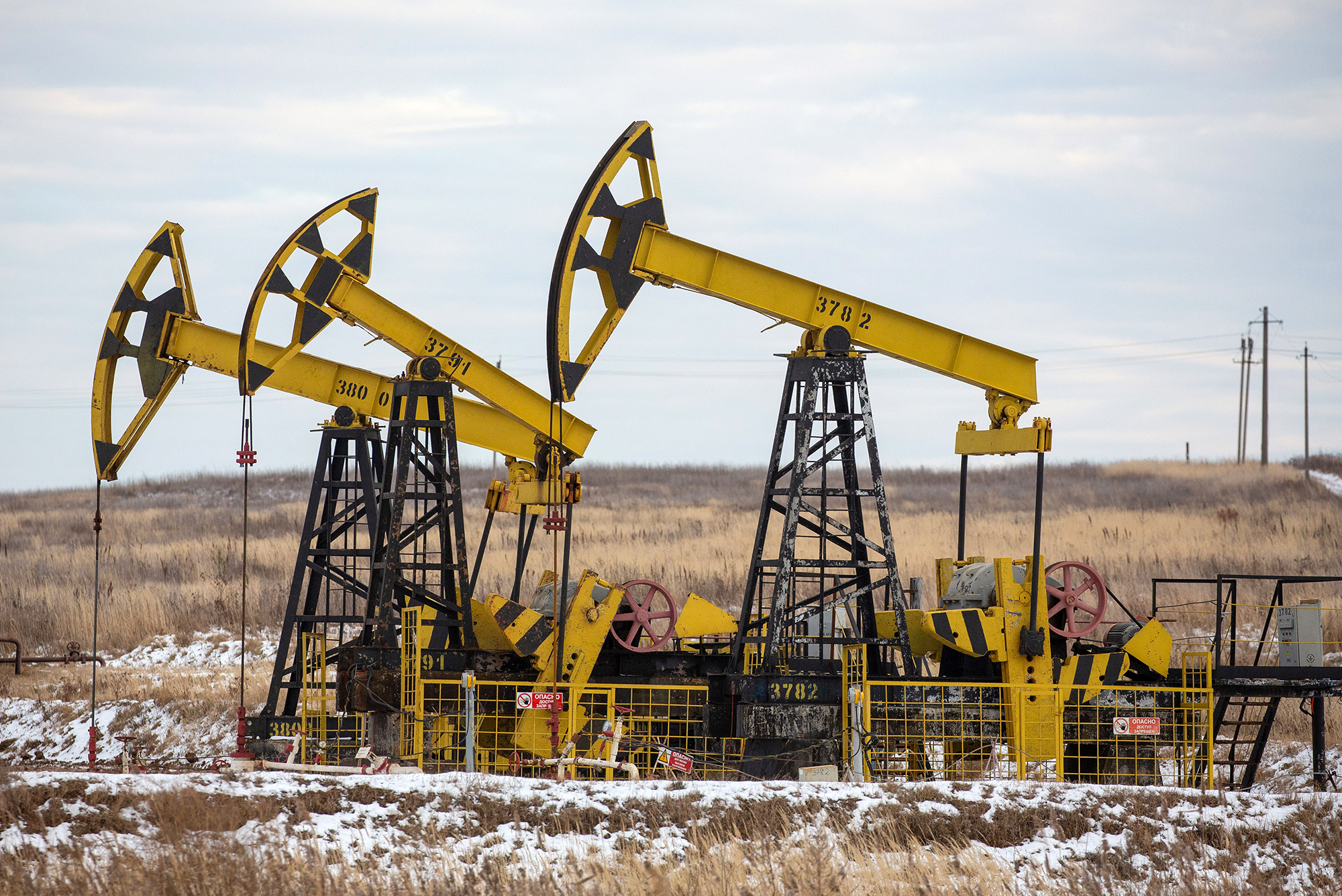 Oil pumping jacks in a Rosneft oilfield near Sokolovka village, Russia. 