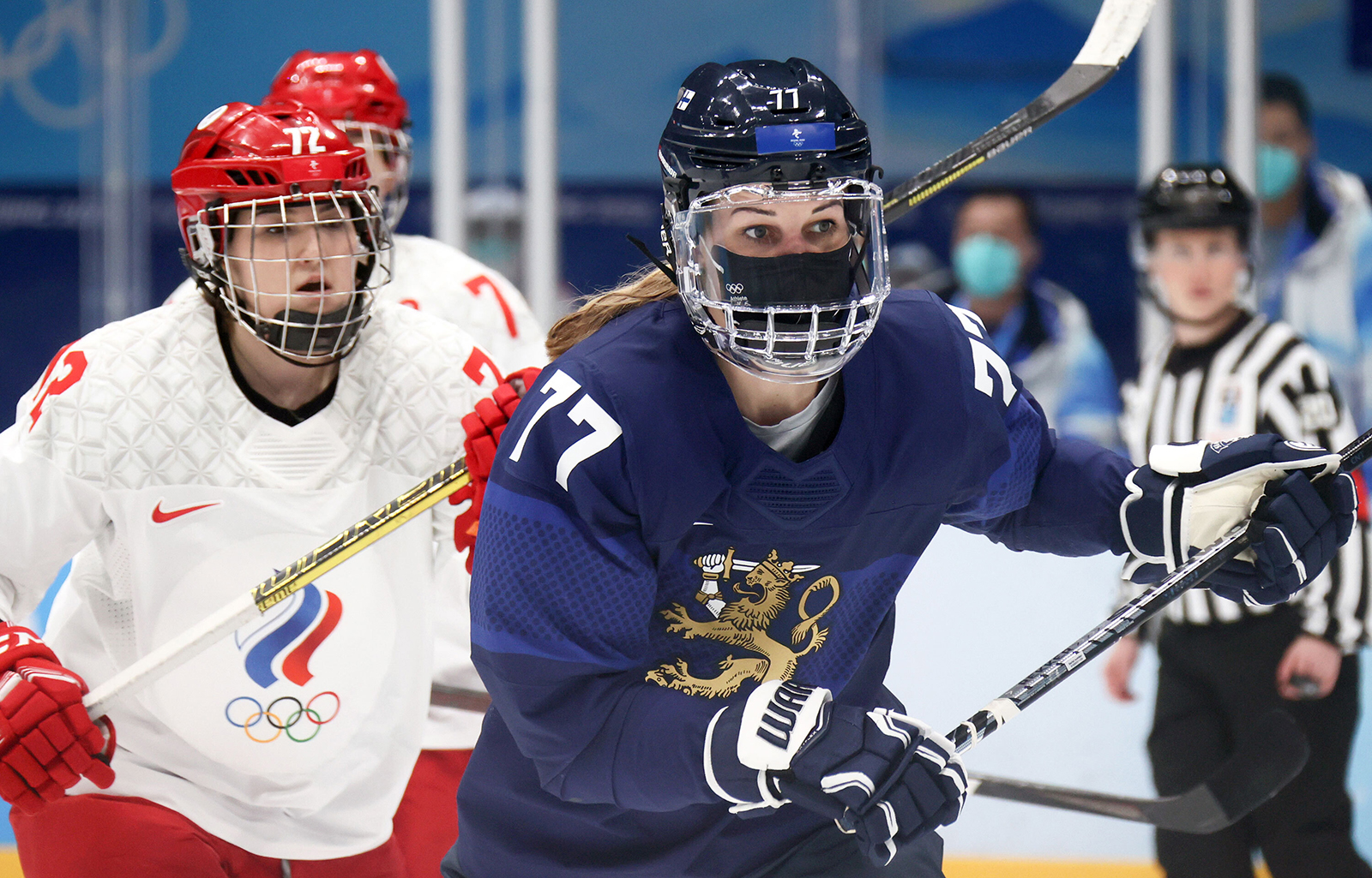 Anna Savonina (L) of the ROC Team and Susanna Tapani of Finland fight for the puck in their women's Group A ice hockey match on February 8.