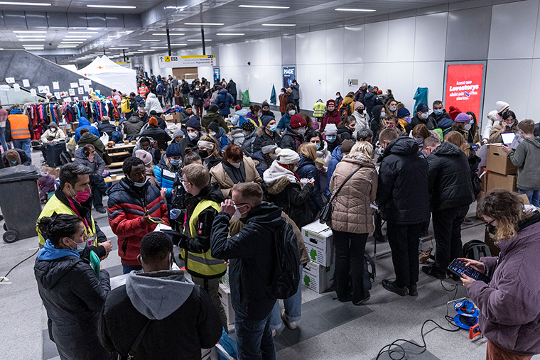 People fleeing Ukraine receive help from volunteers as they arrive on a train from Poland at Hauptbahnhof main railway station on Friday, March 4, in Berlin, Germany. 