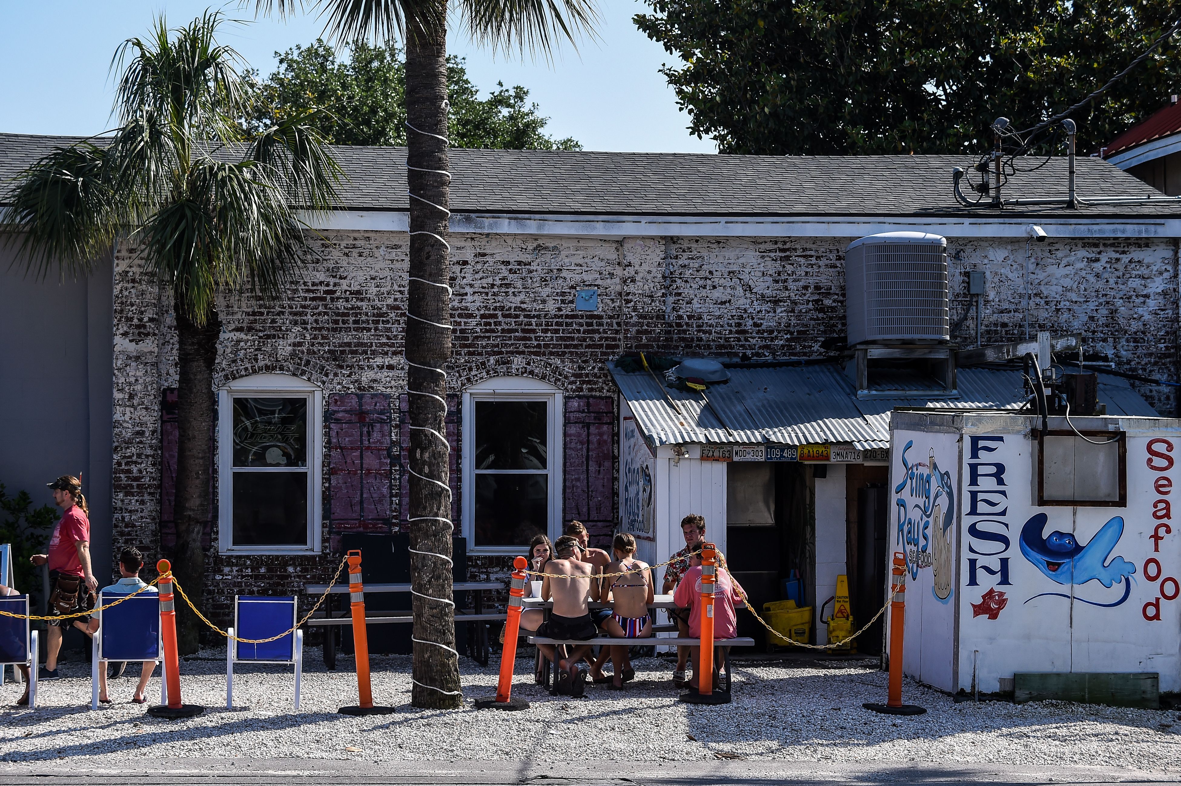 People sit and eat at a roadside food joint in Tybee Island, Georgia, on April 25.