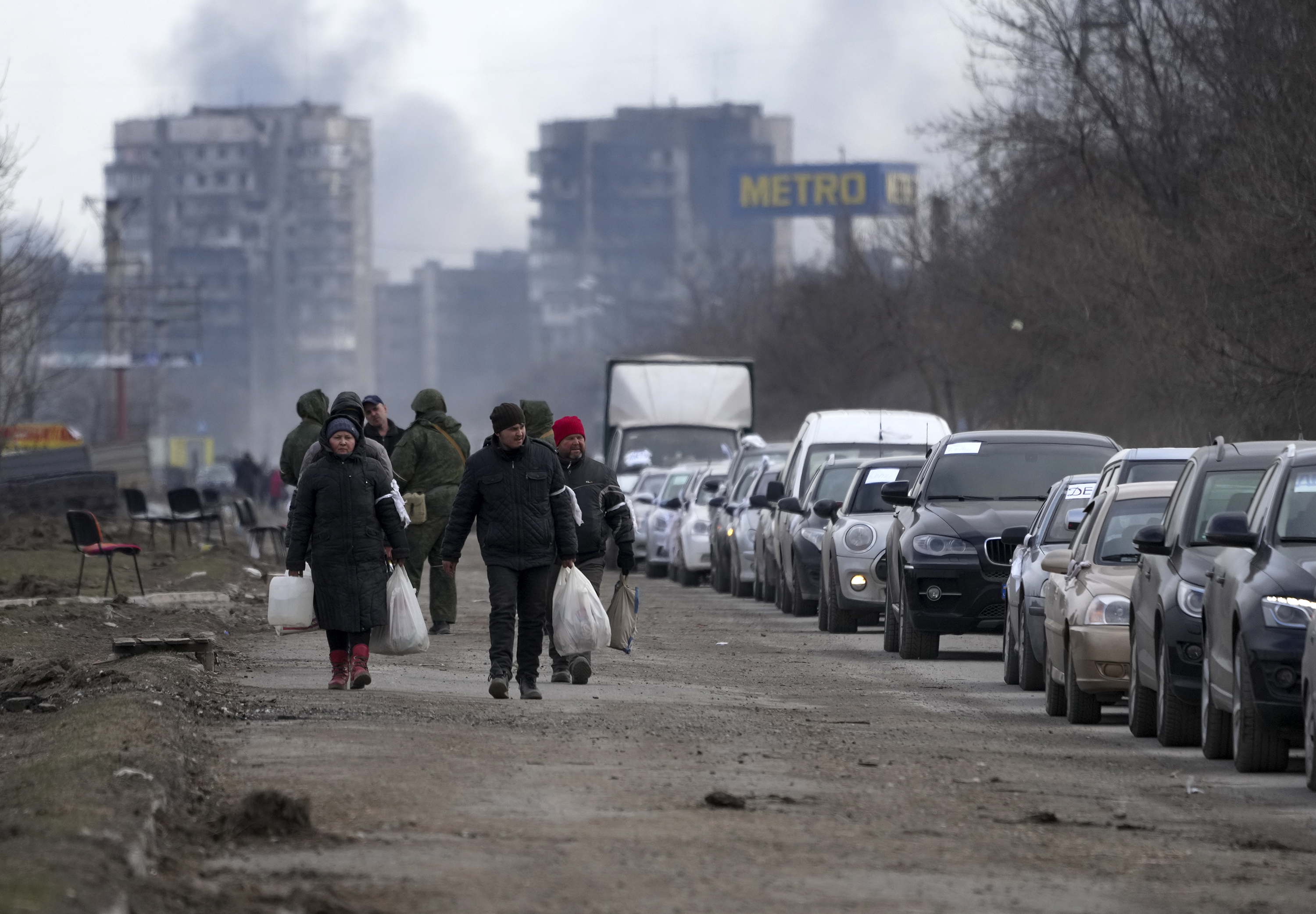 Citizens evacuate Mariupol, Ukraine, on Sunday, March 20. 