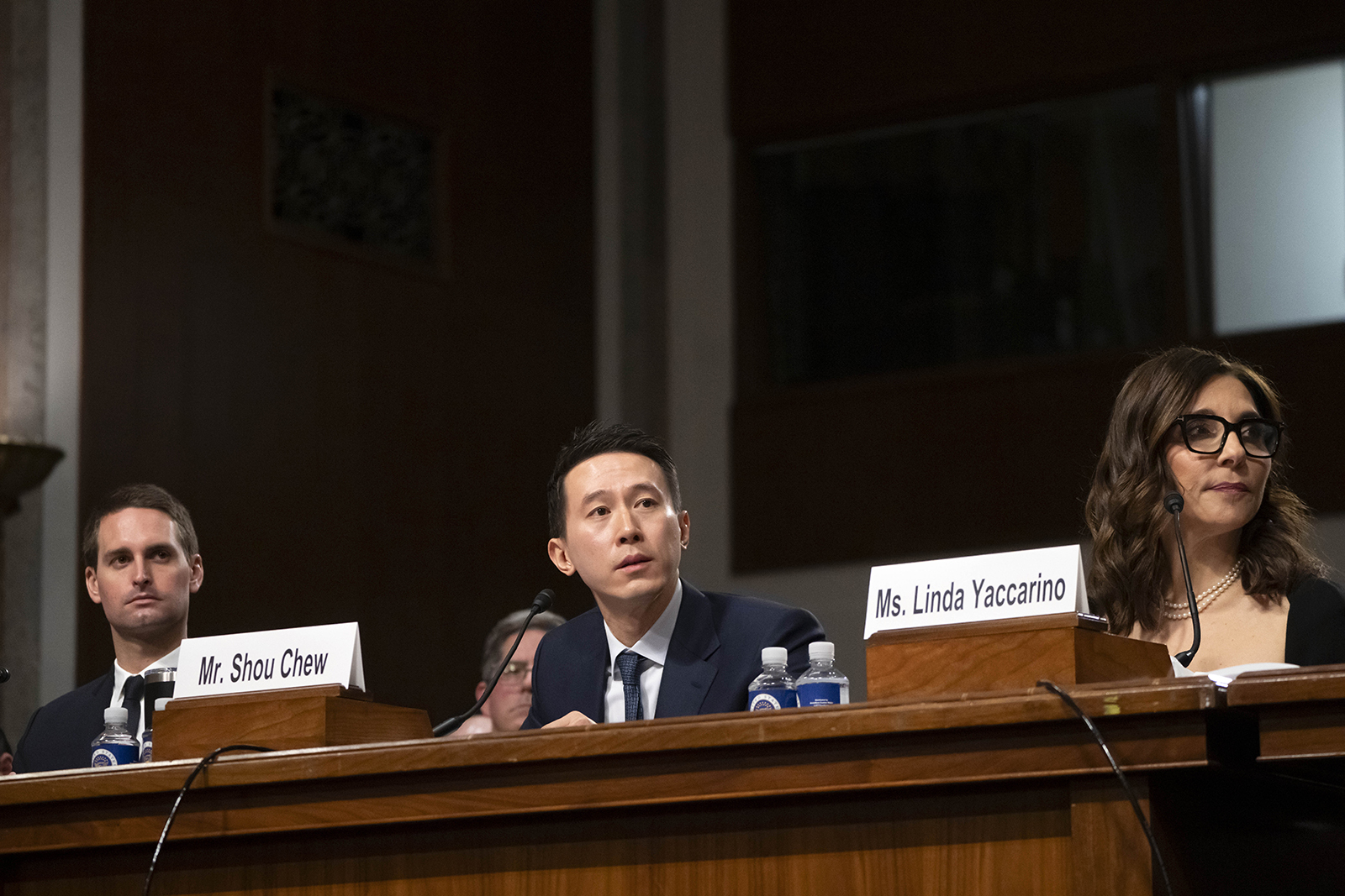 TikTok CEO Shou Zi Chew, center, speaks as Snap CEO Evan Spiegel, left, and X CEO Linda Yaccarino, right, listen during the Senate Judiciary Committee's hearing on online child safety on Capitol Hill, today.