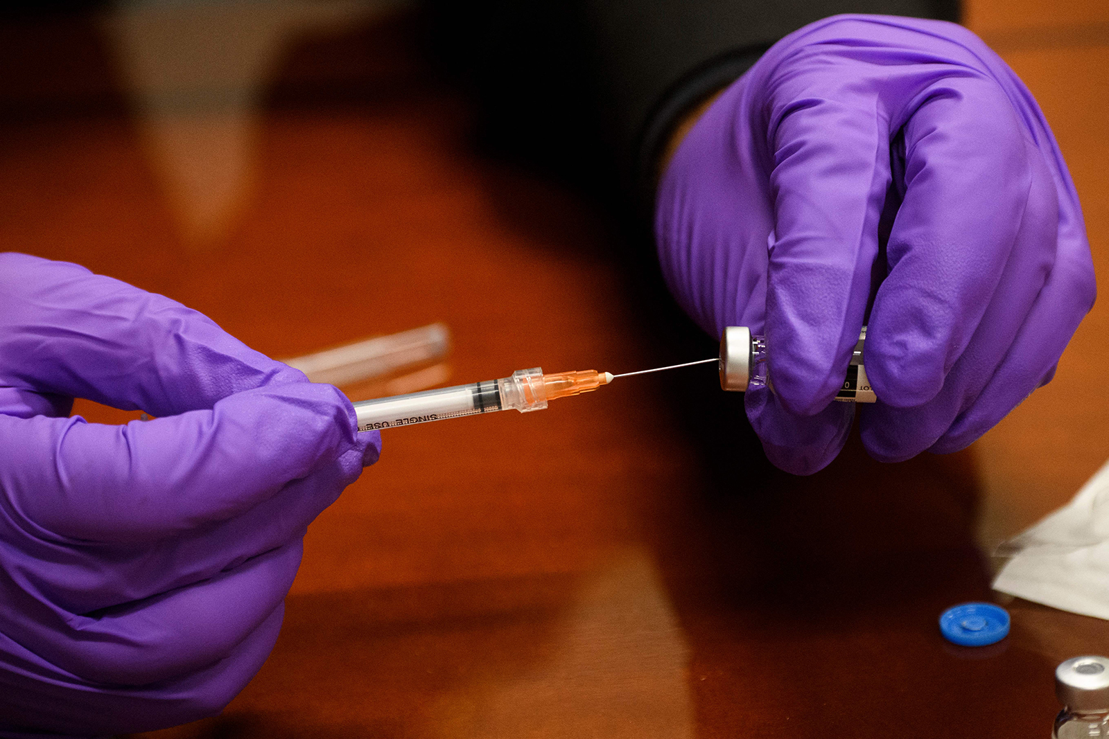 A Culver City Fire Department paramedic prepares a syringe with a dose of the Johnson & Johnson Covid-19 vaccine at a vaccination clinic on August 5 in California.