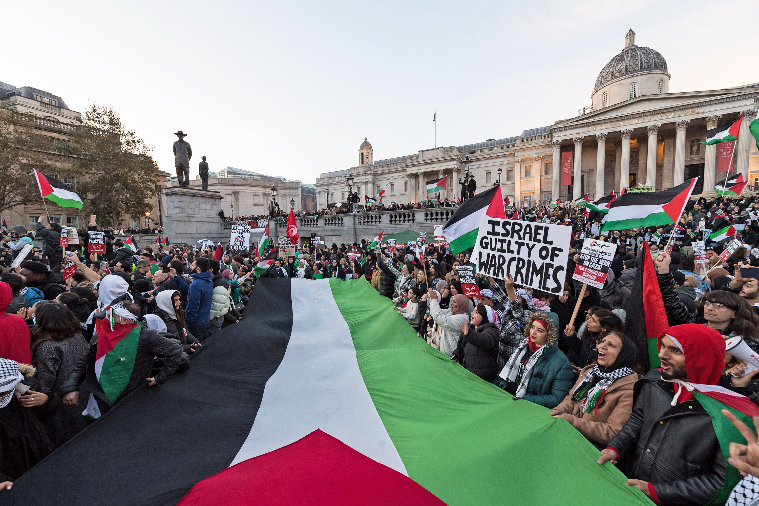 People gather as they carry Palestinian flags and banners to demonstrate solidarity with the Palestinians and demand an immediate ceasefire at Trafalgar Square in London, United Kingdom on November 4.
