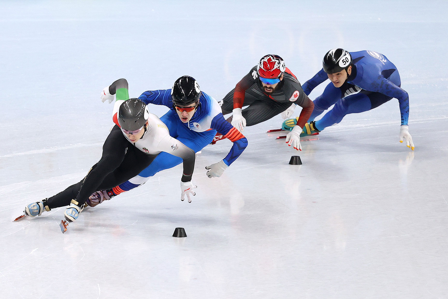 Athletes from Hungary, the ROC, Canada and Kazakhstan skate during the men's 500m short track speed skating event on February 13.