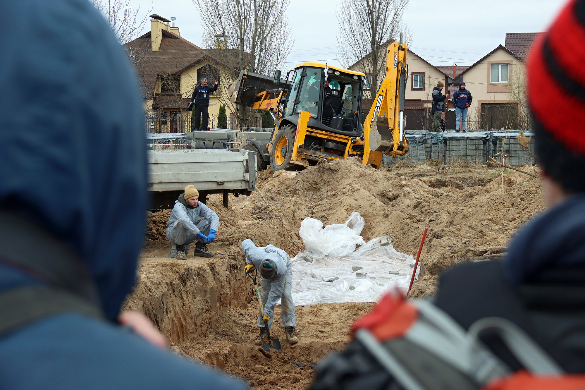 The exhumation of civilian bodies from a mass grave in Bucha, Ukraine, on April 13.