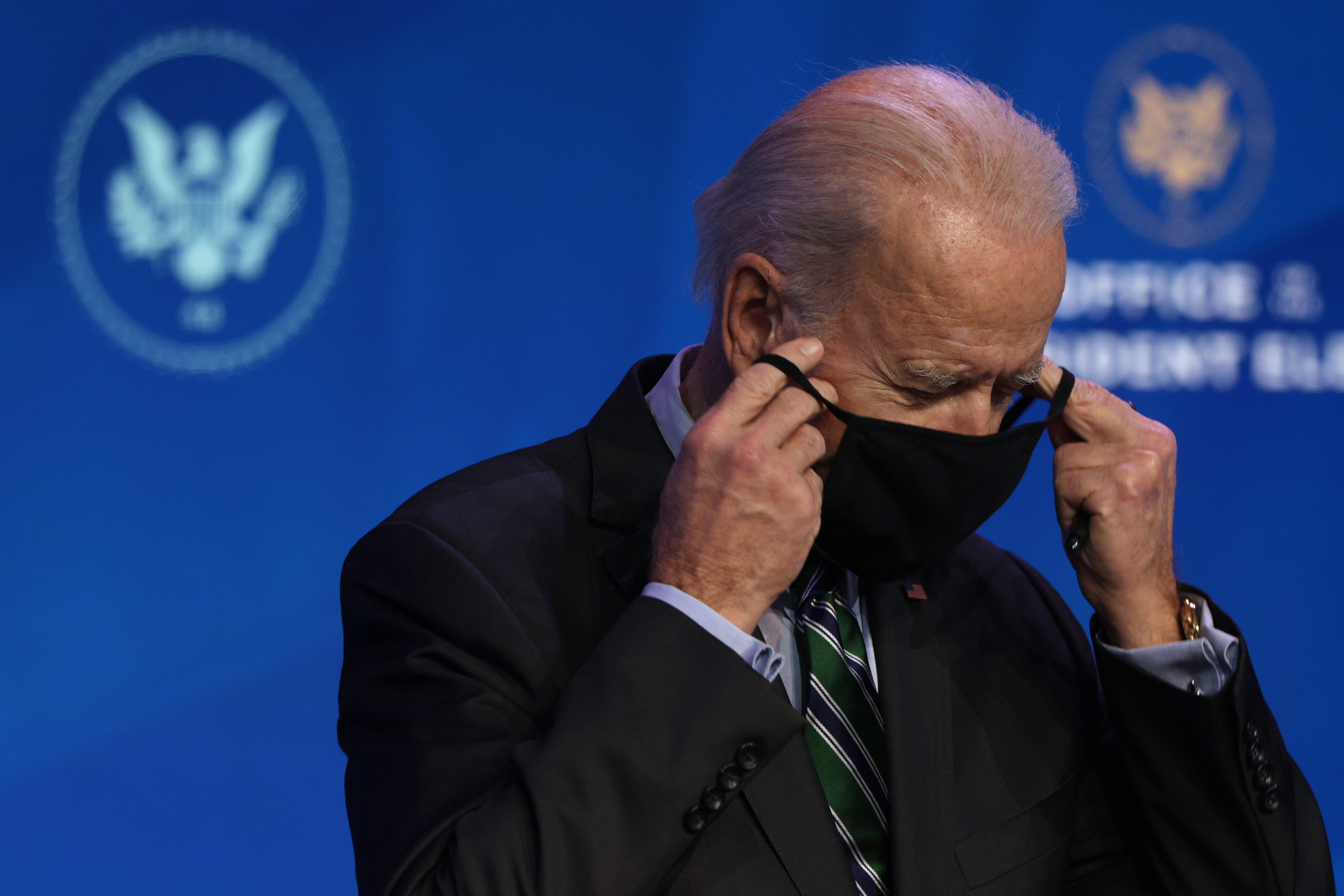 US President-elect Joe Biden puts his mask on after an announcement on Saturday in Wilmington, Delaware.