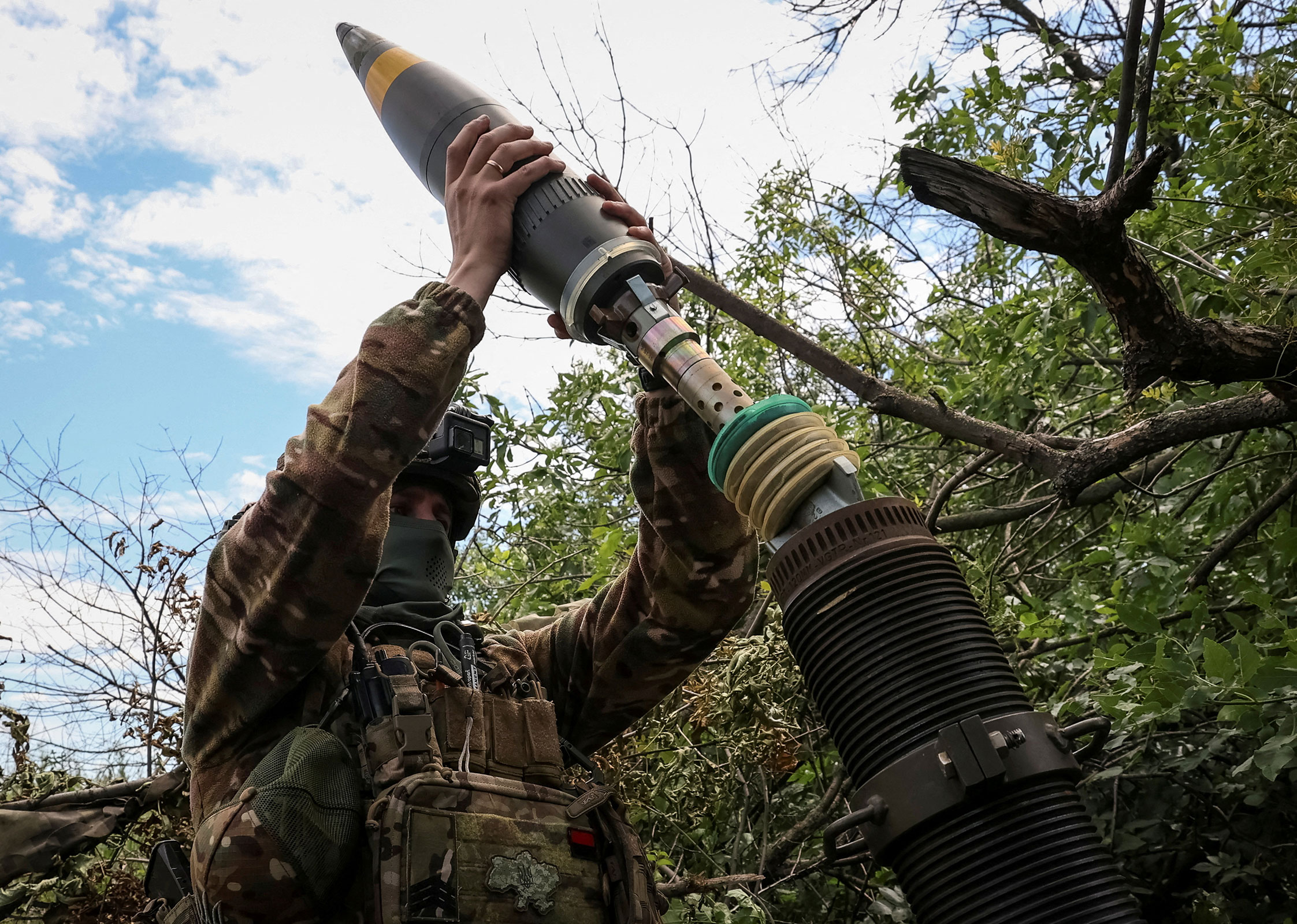 A Ukrainian service member prepares to fire a mortar near the city of Bakhmut in the Donetsk region on July 13, 2023. 
