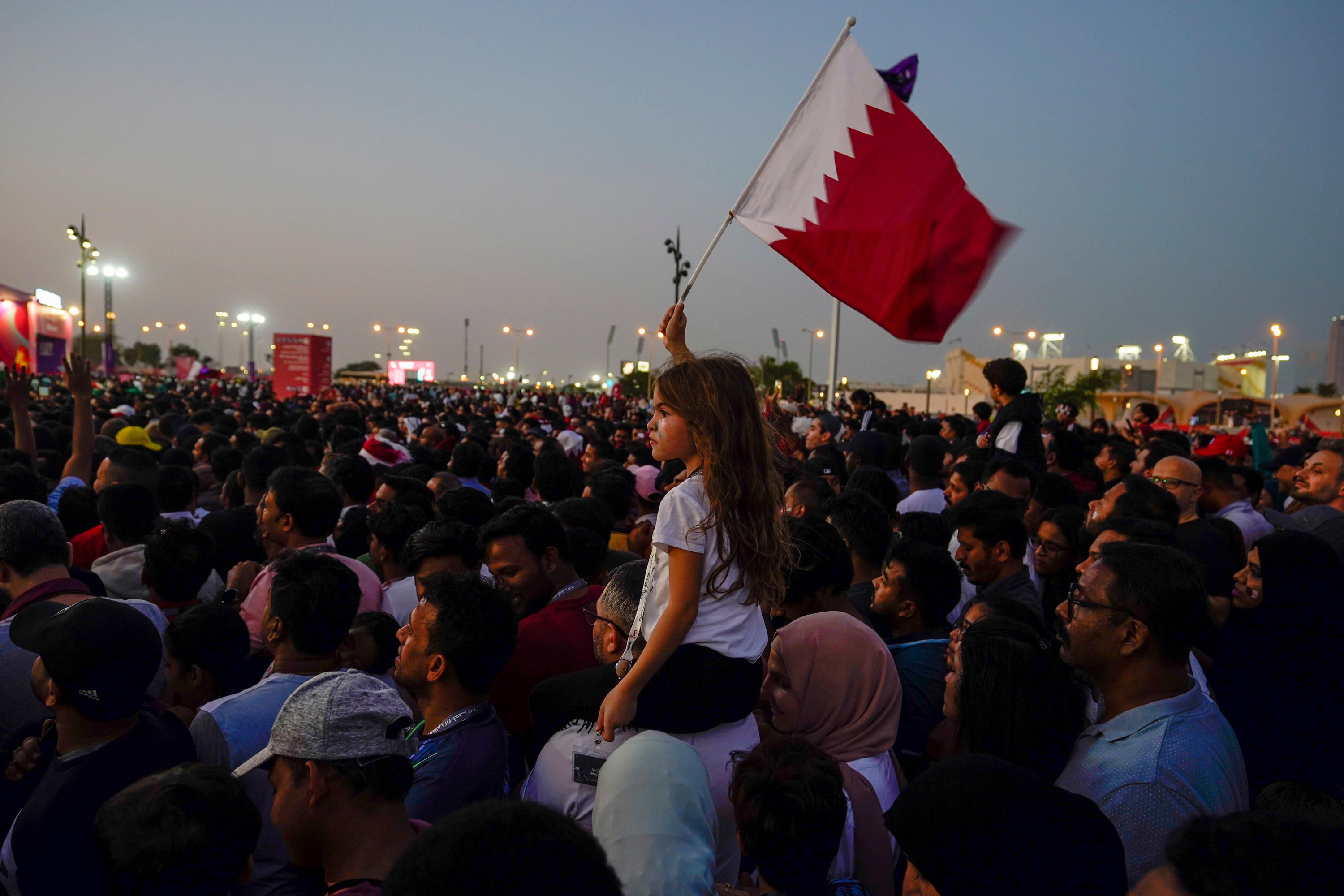 A girl waves a Qatari flag during the opening ceremony for the World Cup prior to the match between Qatar and Ecuador, in Doha, Qatar on November 20.