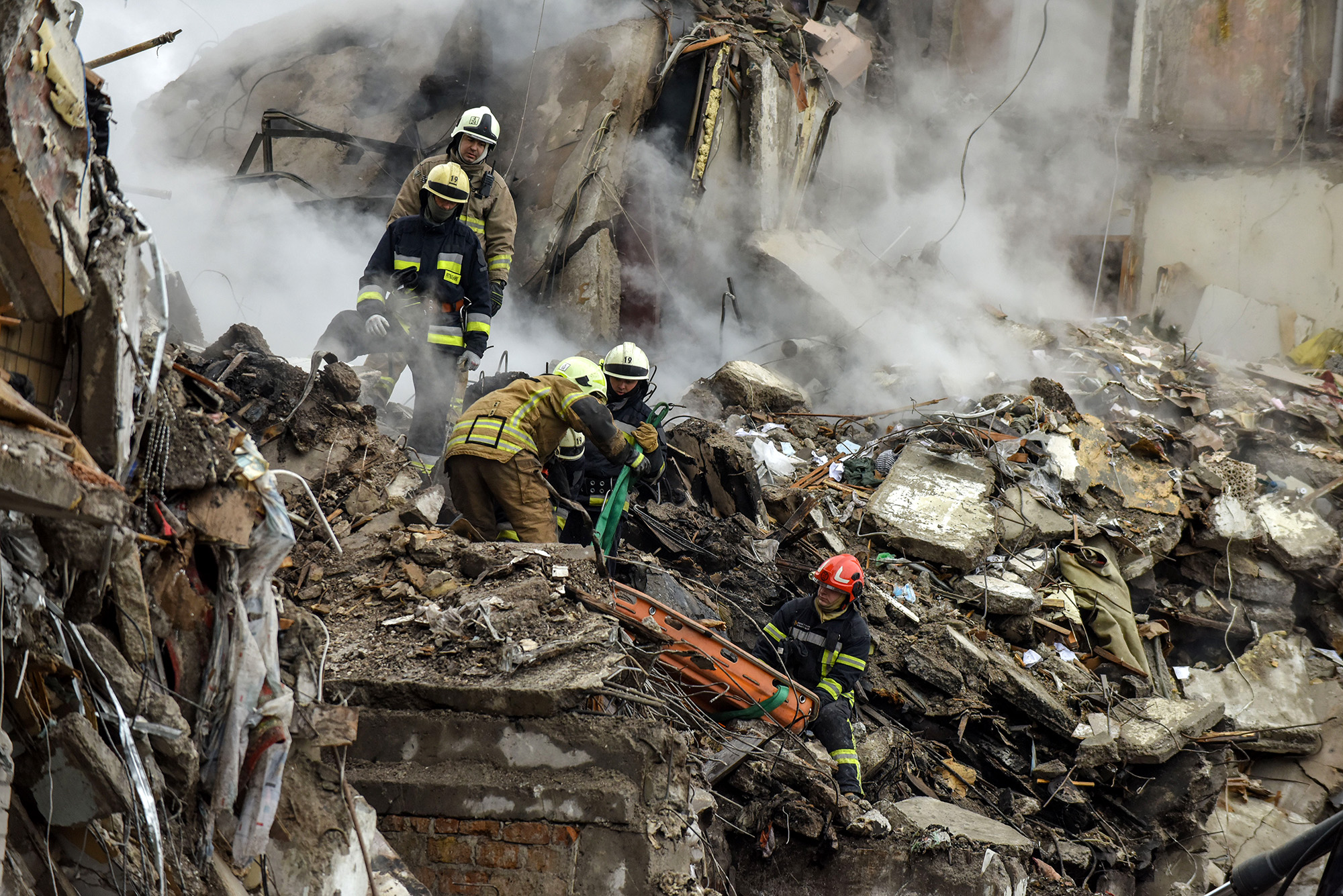 Rescue workers remove the body of a victim from the debris of a damaged residential building in Dnipro, southeastern Ukraine, on January 15.