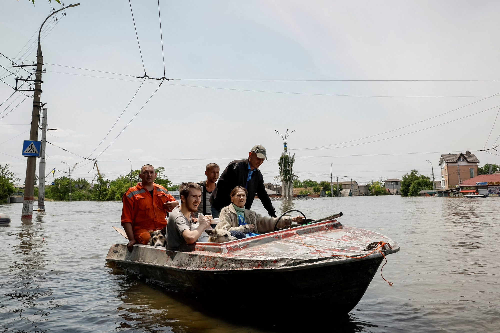 Volunteers evacuate residents from a flooded area in Kherson on Thursday.
