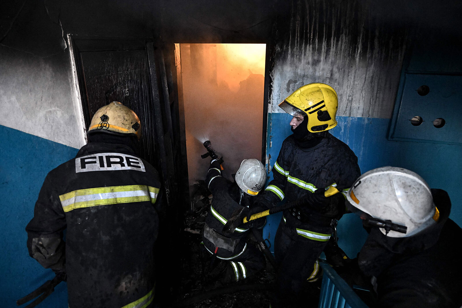 Firefighters attempt to extinguish a fire after a reported strike in the eastern Ukraine town of Chuhuiv on February 24.