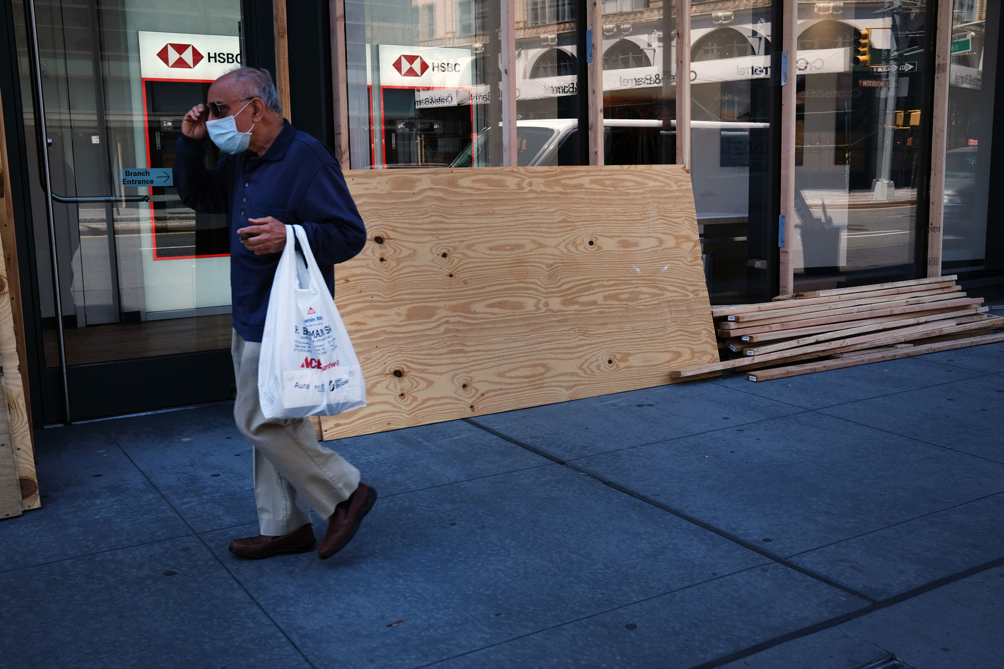 People walk through a central shopping district as stores prepare for gradual reopenings in the coming weeks on June 16 in New York.