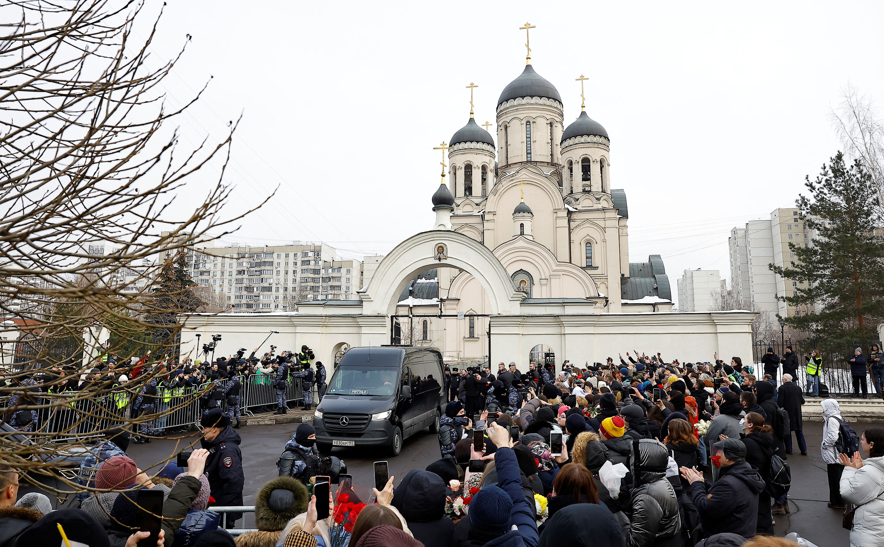 The hearse carrying Alexey Navalny's casket is parked outside the Church of the Icon of the Mother of God 'Quench My Sorrows' in Moscow before the funeral service on Friday.