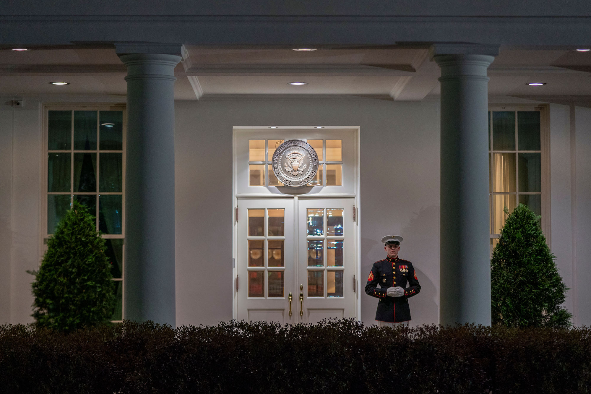 A US Marine guards the entrance to the West Wing of the White House on Saturday.