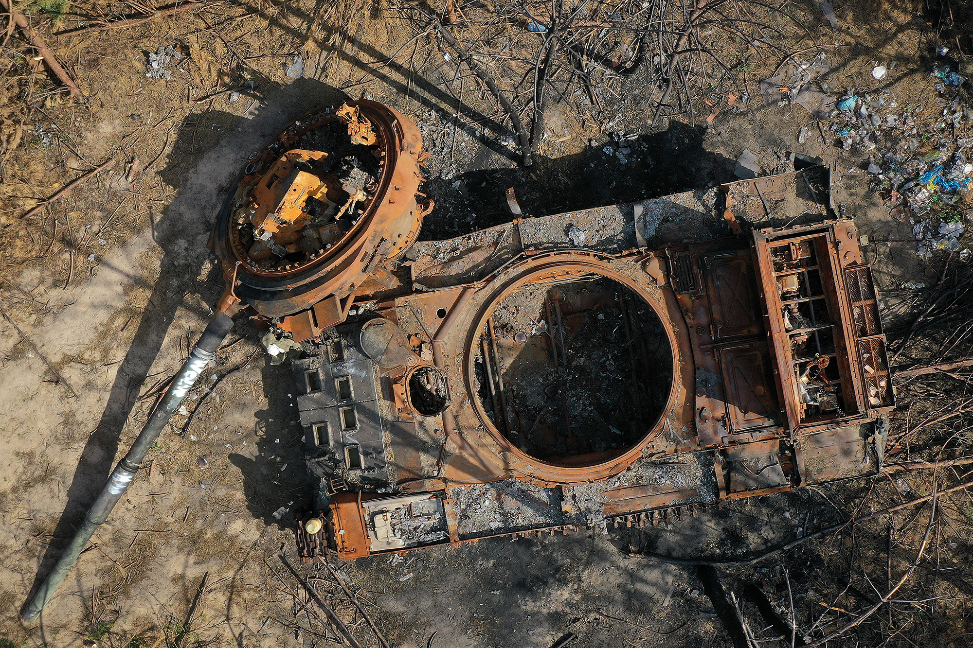 A destroyed Russian tank begins to rust in woodland near Kyiv, Ukraine, on June 7.
