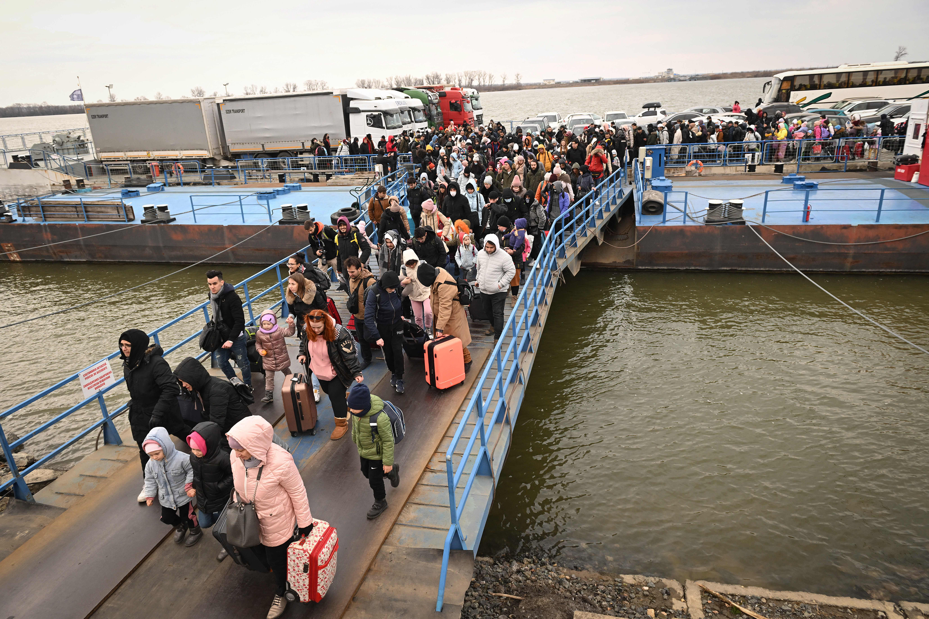 People coming from Ukraine disembark a ferry boat in Romania, on February 26. 