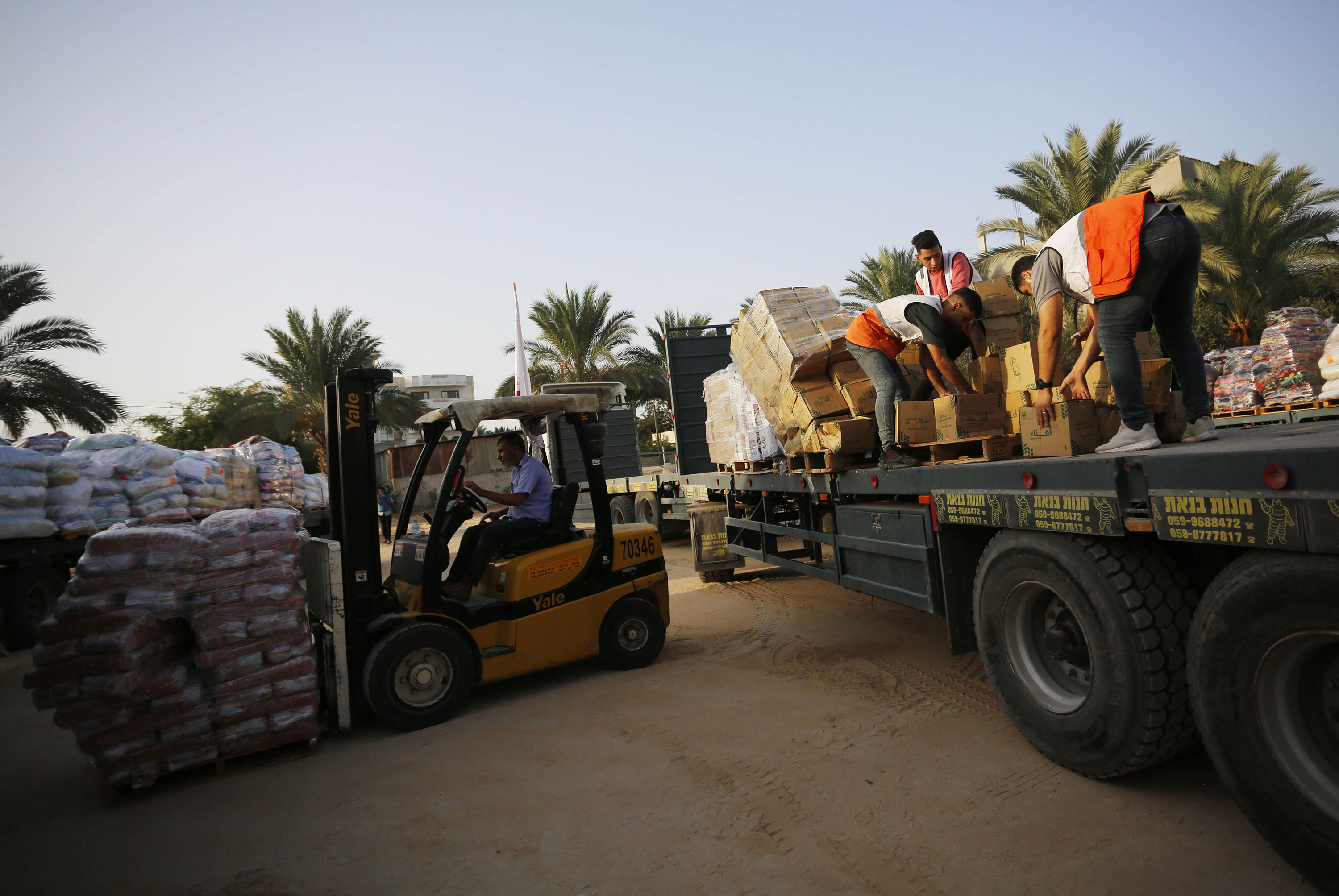 Members of Palestine Red Crescent Society organize humanitarian aid sent by the World Health Organization, after entering Gaza through the Rafah border crossing in Khan Younis, Gaza, on Monday.