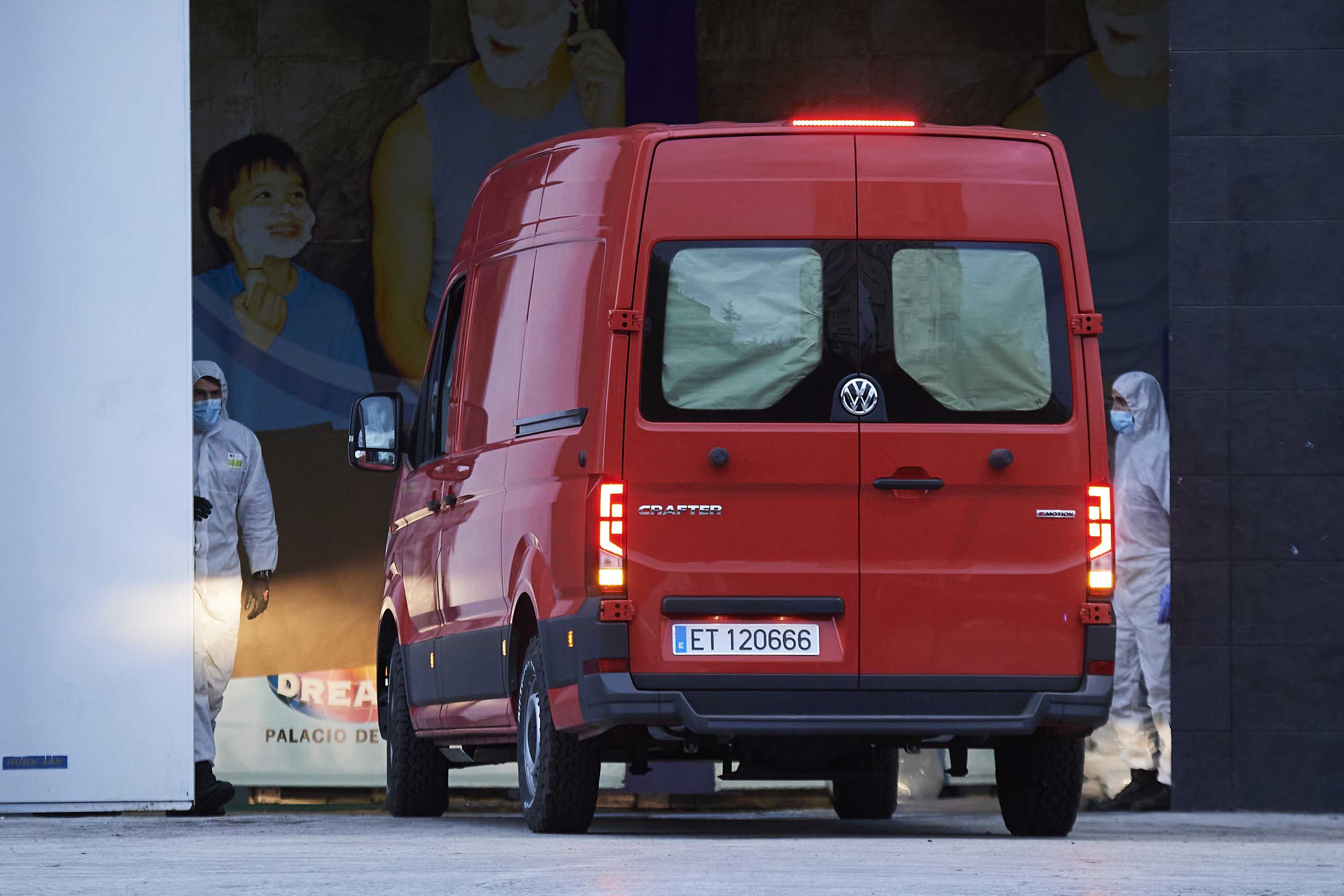 Deceased victims of the virus are transported to the Palacio de Hielo ice rink in Madrid on Tuesday, which has been converted into a morgue.