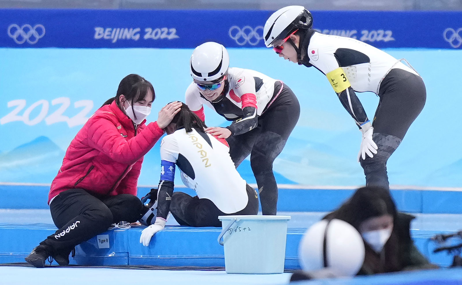 Japan's Nana Takagi is consoled by her teammates after falling during the women's team pursuit final on February 15.