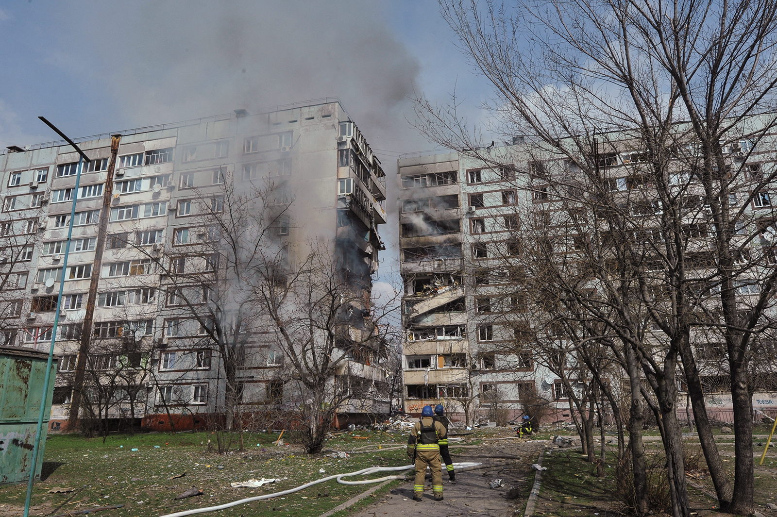 Rescuers stand in front of a residential building damaged by a Russian missile strike in Zaporizhzhia, Ukraine on March 22.