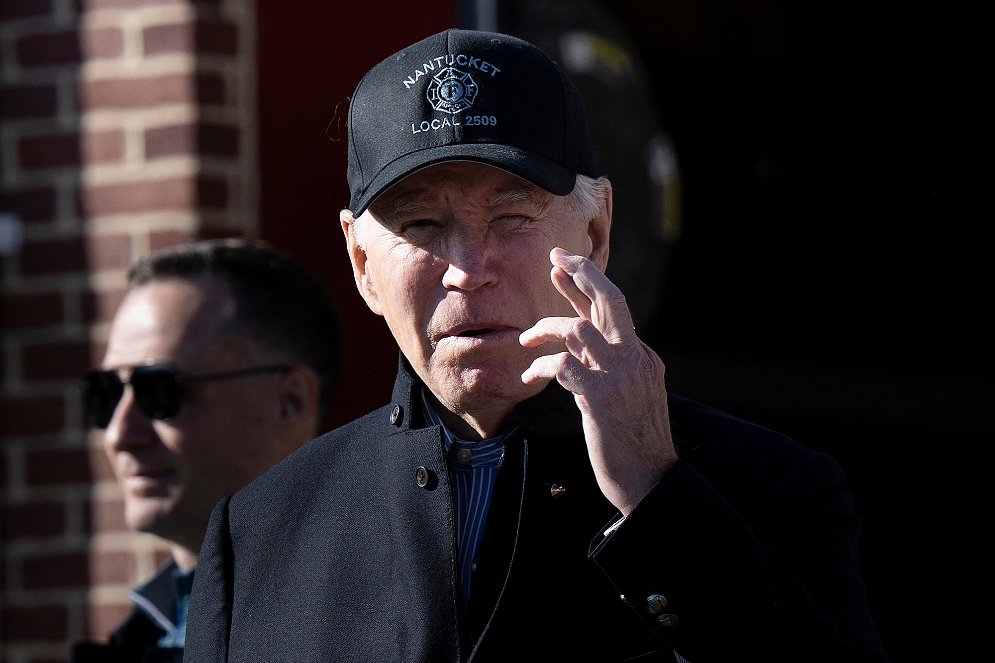 US President Joe Biden crosses his fingers while responding to a question about the release of Hamas hostages after a visit to the Nantucket Fire Department on Thanksgiving today in Nantucket, Massachusetts. 