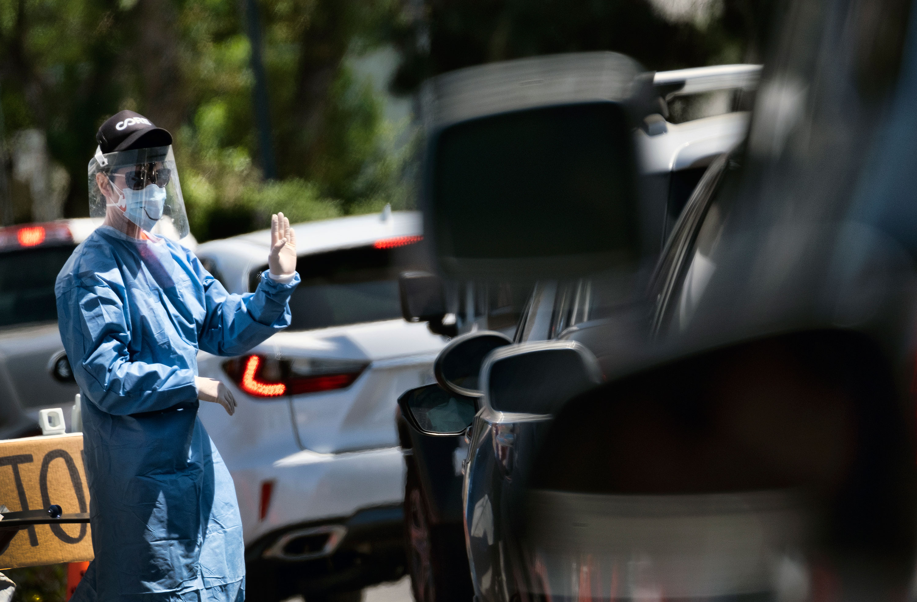 A volunteer directs cars lining up for coronavirus testing in Los Angeles on May 2.