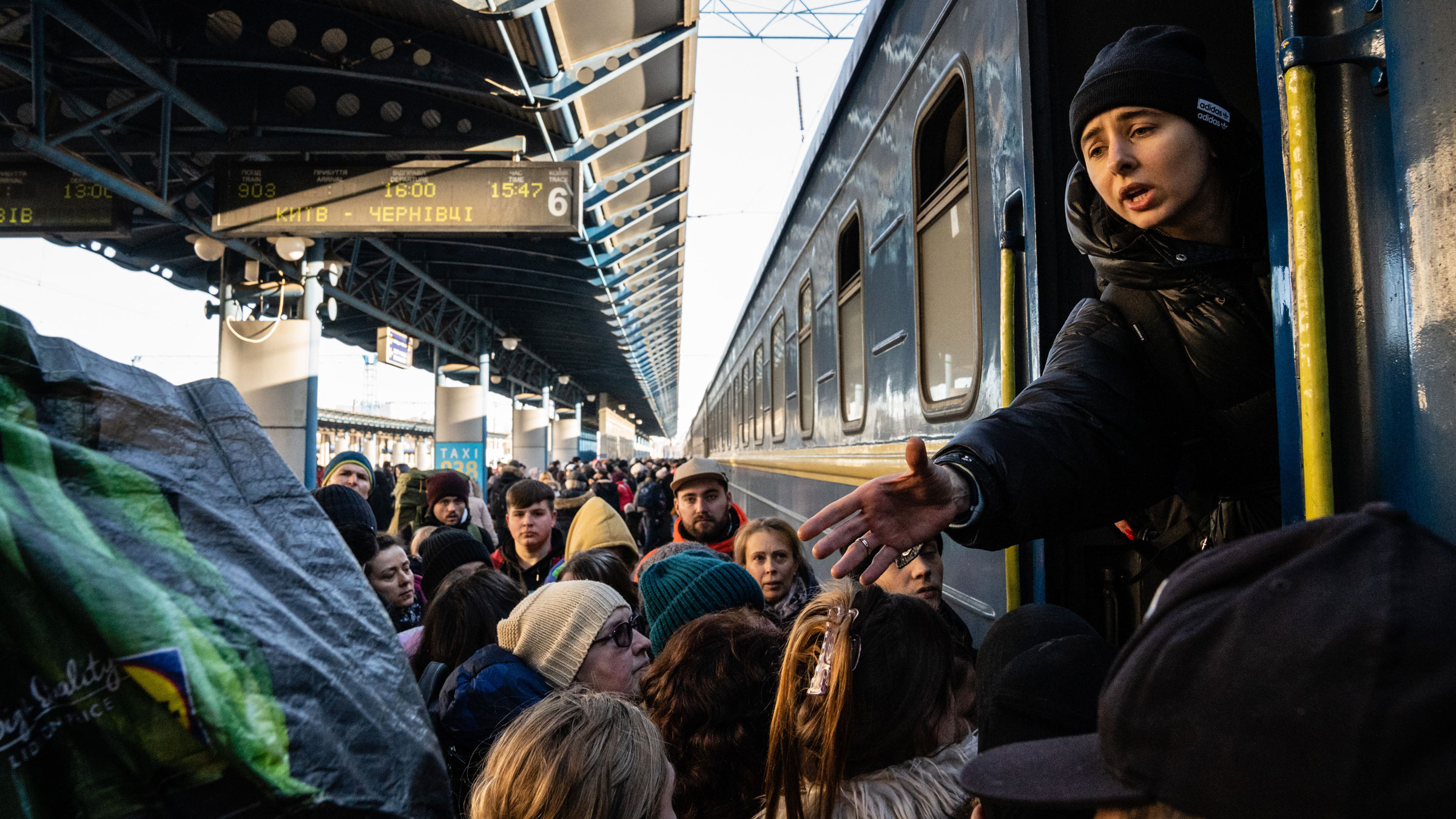 Passengers anxiously board trains in Kyiv before heading to destinations in the western part of the country on Monday.