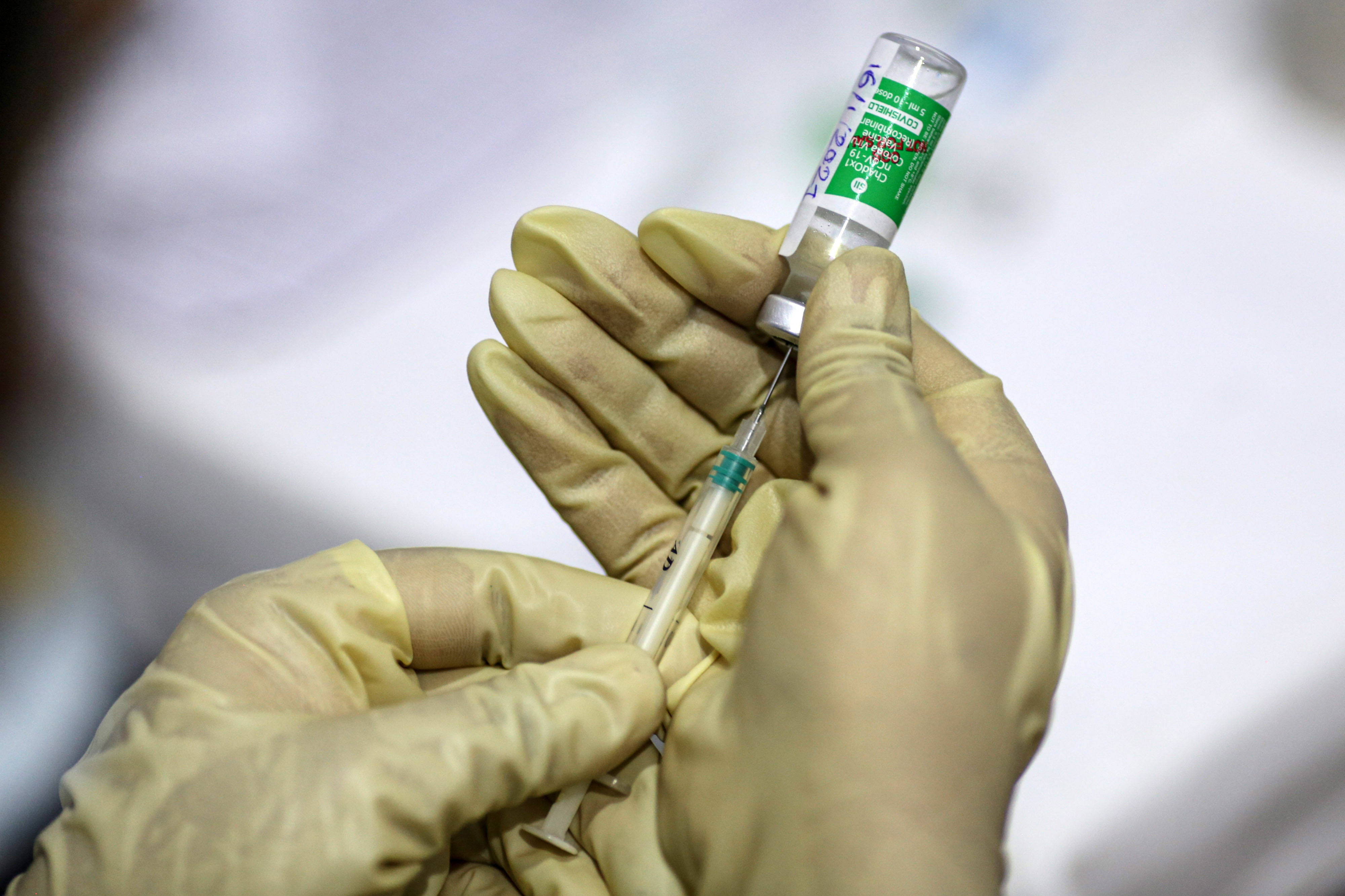 A nurse draws from a vial of the Covishield vaccine — developed by Oxford University and AstraZeneca, and manufactured by the Serum Institute of India — at a hospital in Mumbai, India, on January 16.