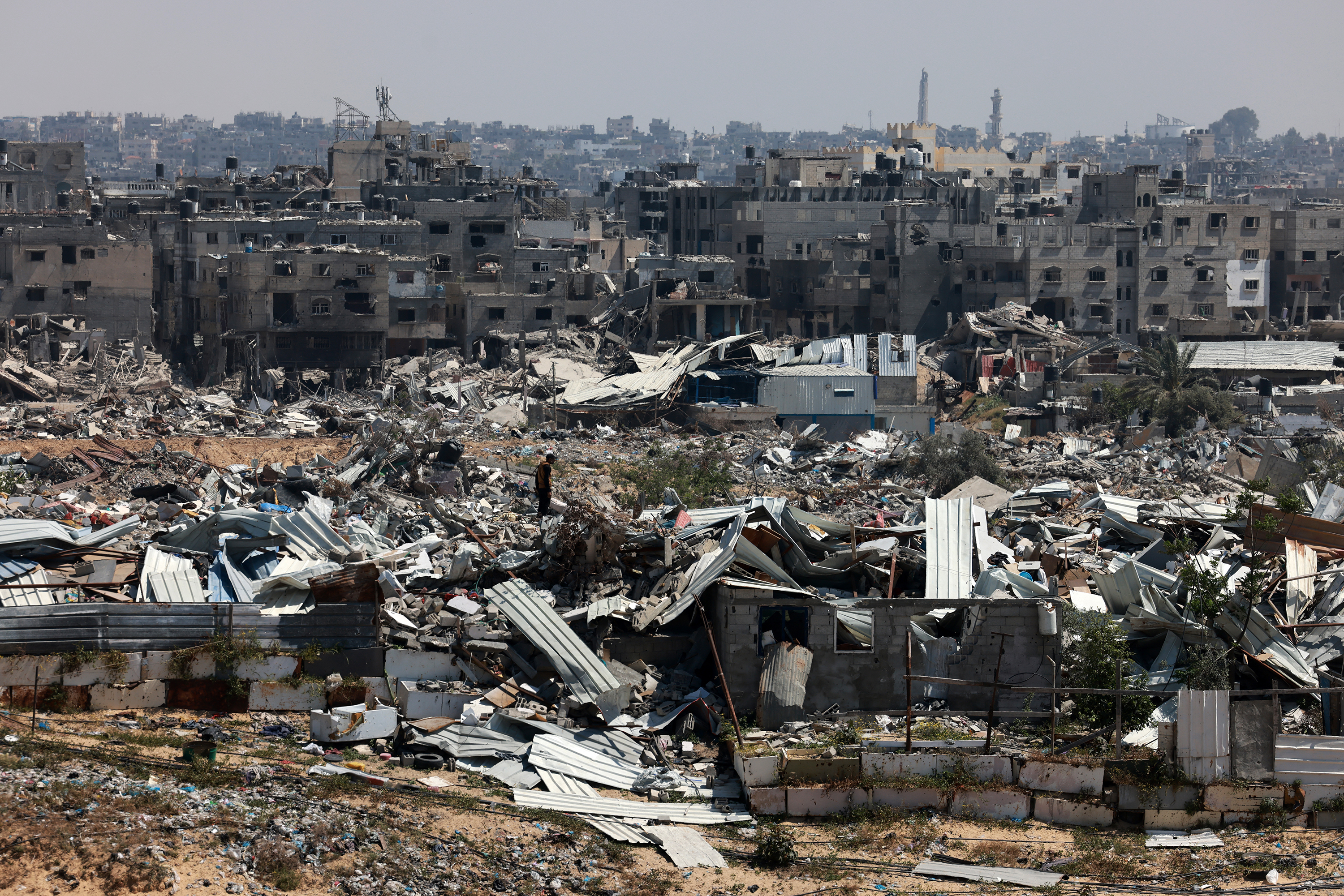 A man stands among damaged and destroyed buildings in Khan Younis, Gaza, on April 7. 