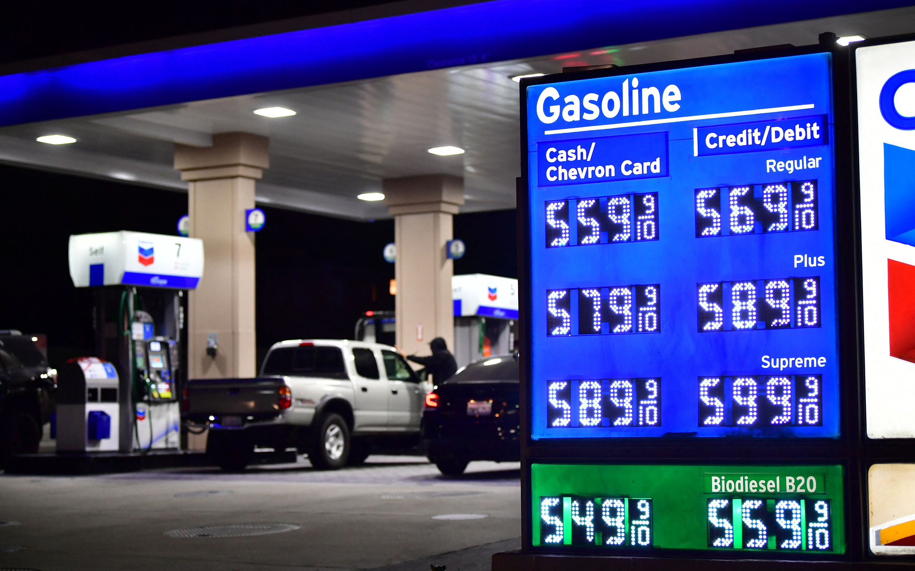 People fill their cars where prices for gas and diesel fuel are over $5 a gallon at a petrol station in Monterey Park, California on March 4, 2022.