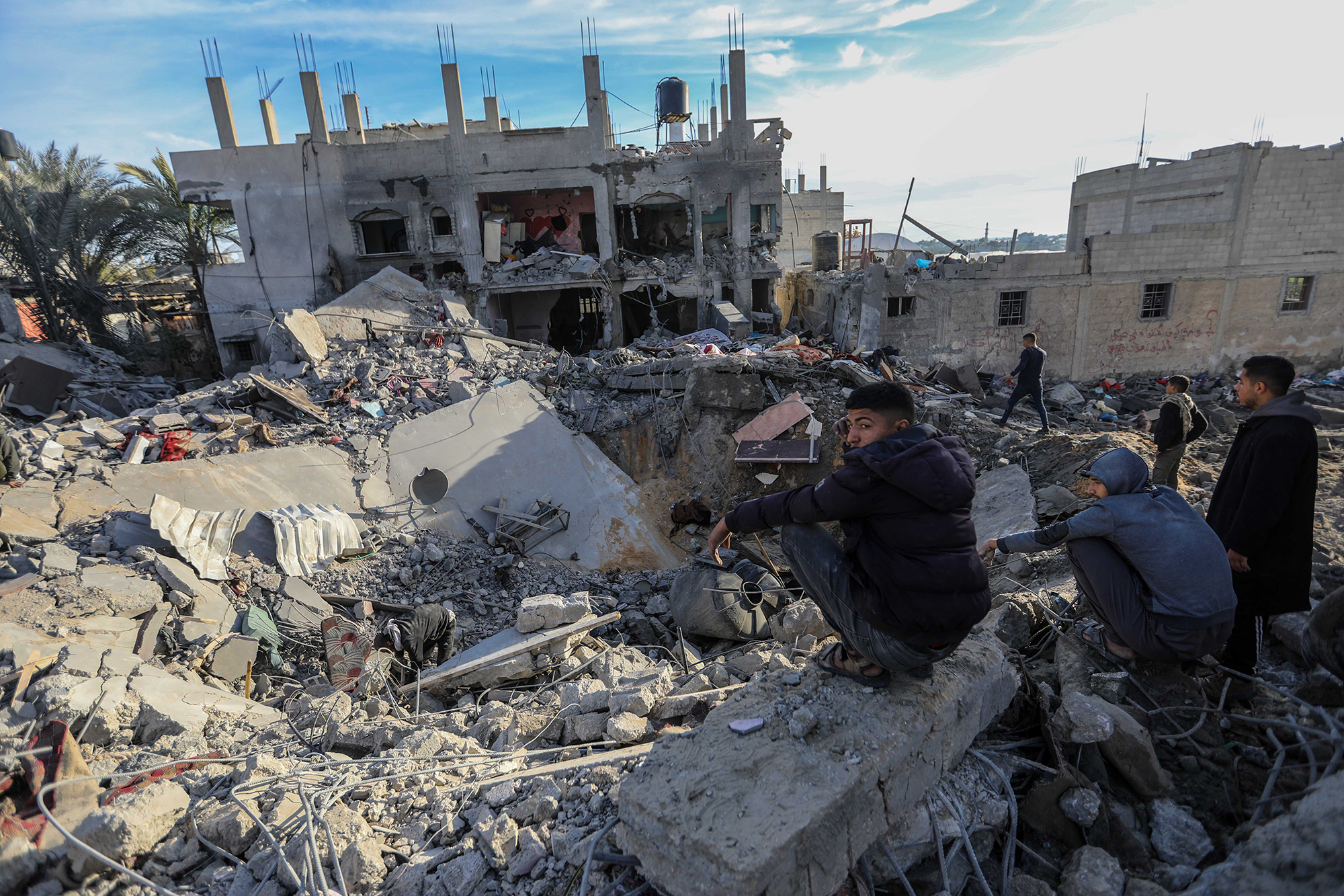 People inspect the damage to their homes following Israeli air strikes in Rafah, Gaza, on February 12.