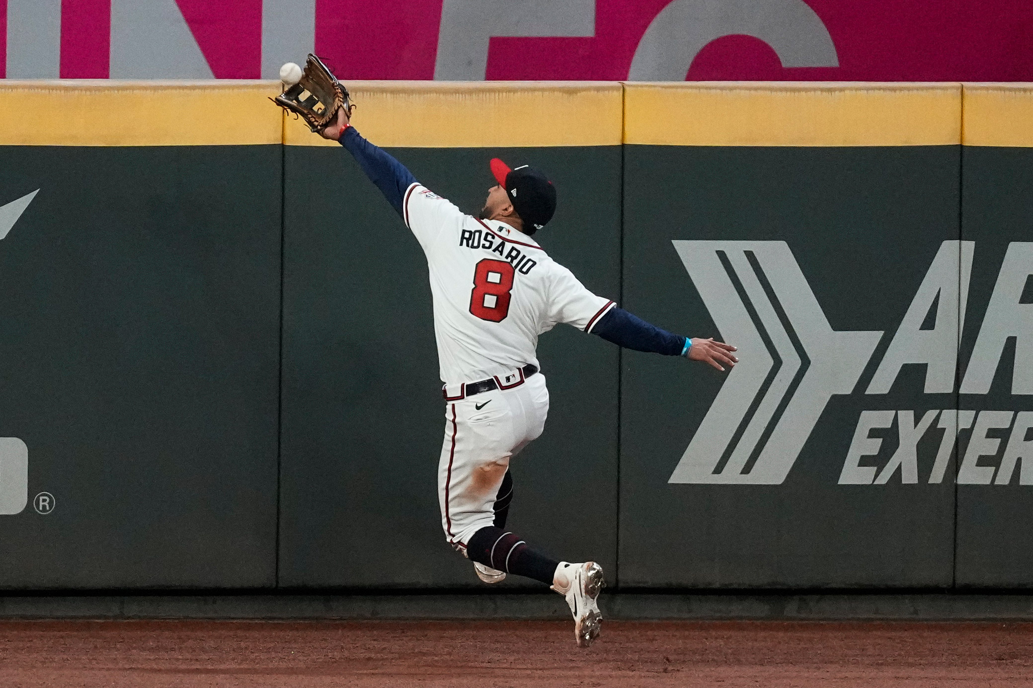 Braves left fielder Eddie Rosario catches a fly ball hit by the Astros' Jose Altuve during the eighth inning.