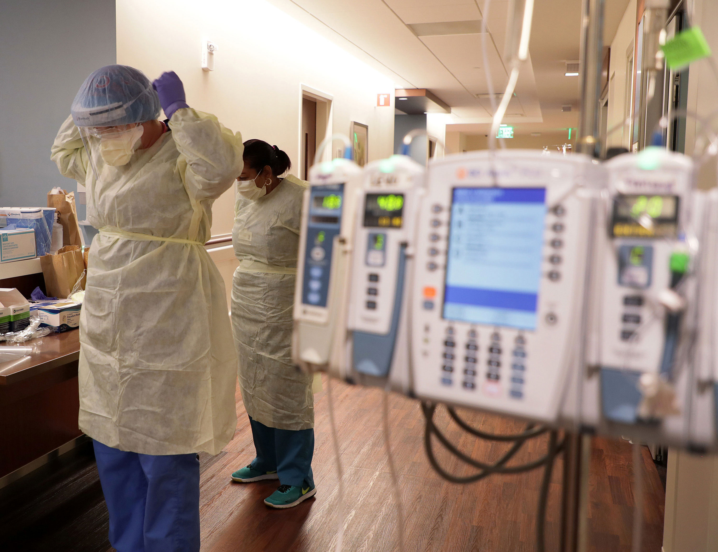 Healthcare workers put on PPE gear before entering a Covid-19 patient's room at Northwestern Medicine Lake Forest Hospital in Lake Forest, Illinois, on October 1.