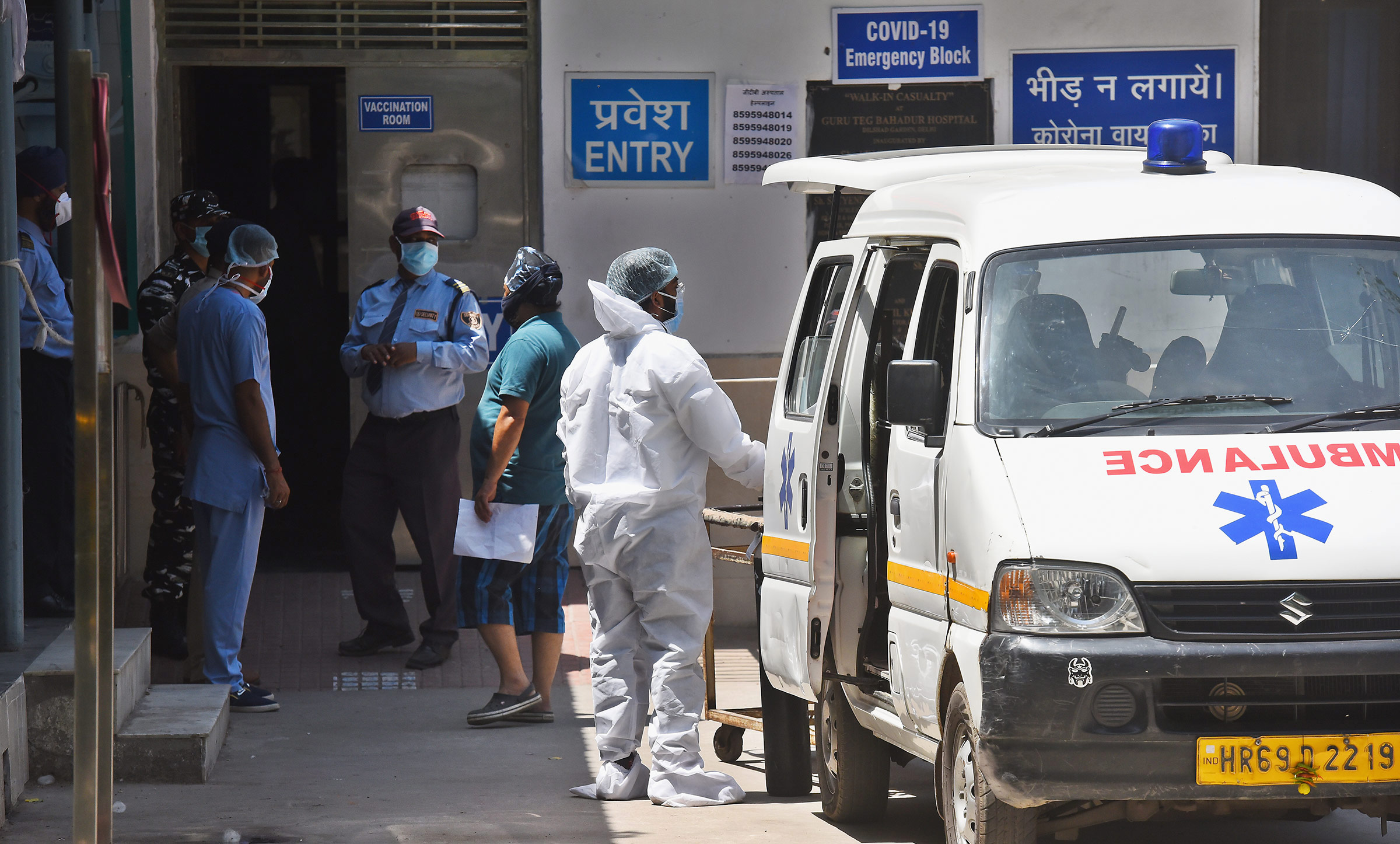 Health workers tend to a Covid-19 patient at Guru Teg Bahadur Hospital on April 25, in New Delhi, India. 