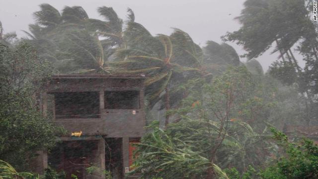 An abandoned house and trees bend from strong winds ahead of the landfall of Cyclone Fani on the outskirts of Puri on Friday. 