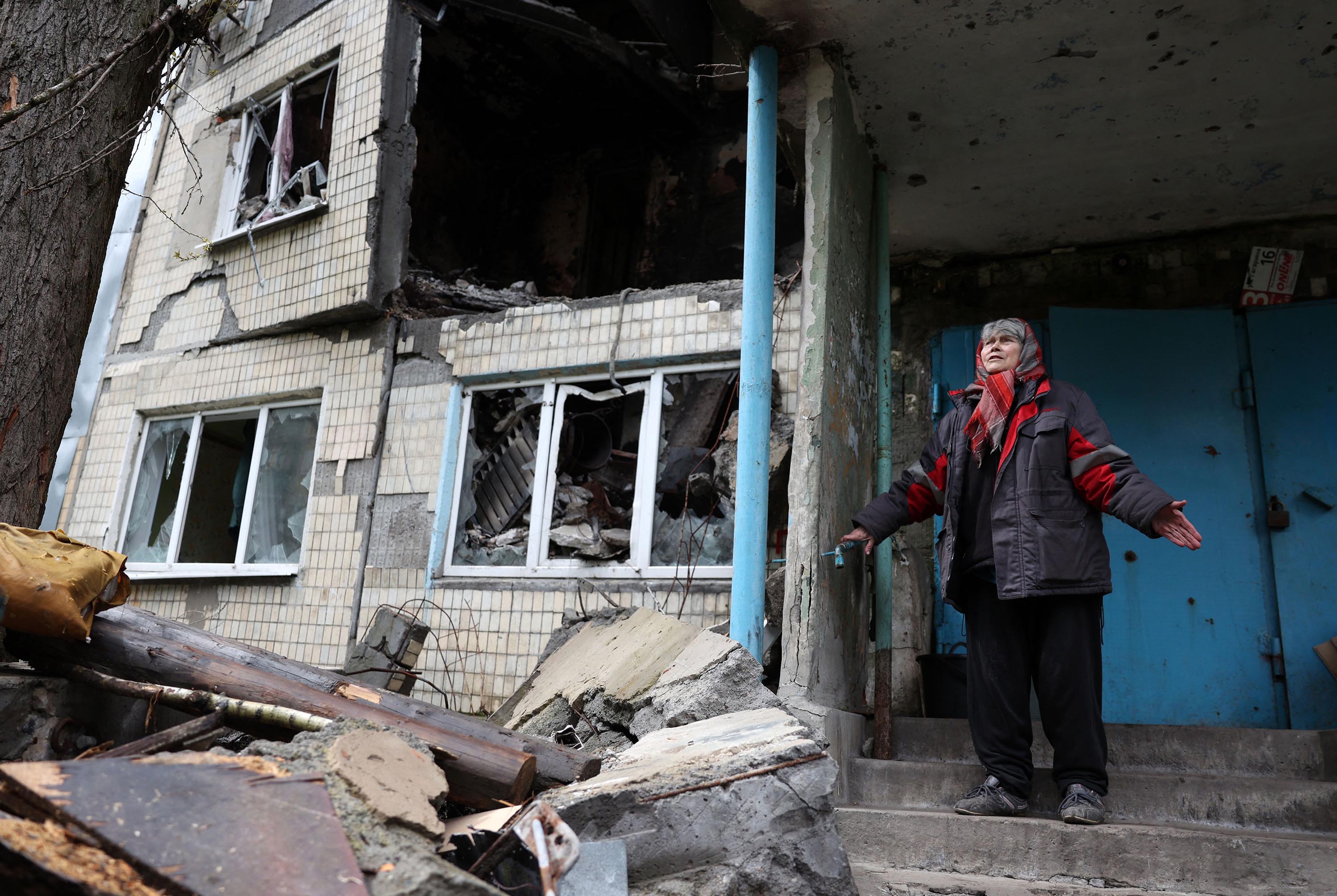 Local resident Ludmyla, 76, stands in front of a heavily damaged residential building in the frontline town of Avdiivka, Donetsk region, on April 25. 