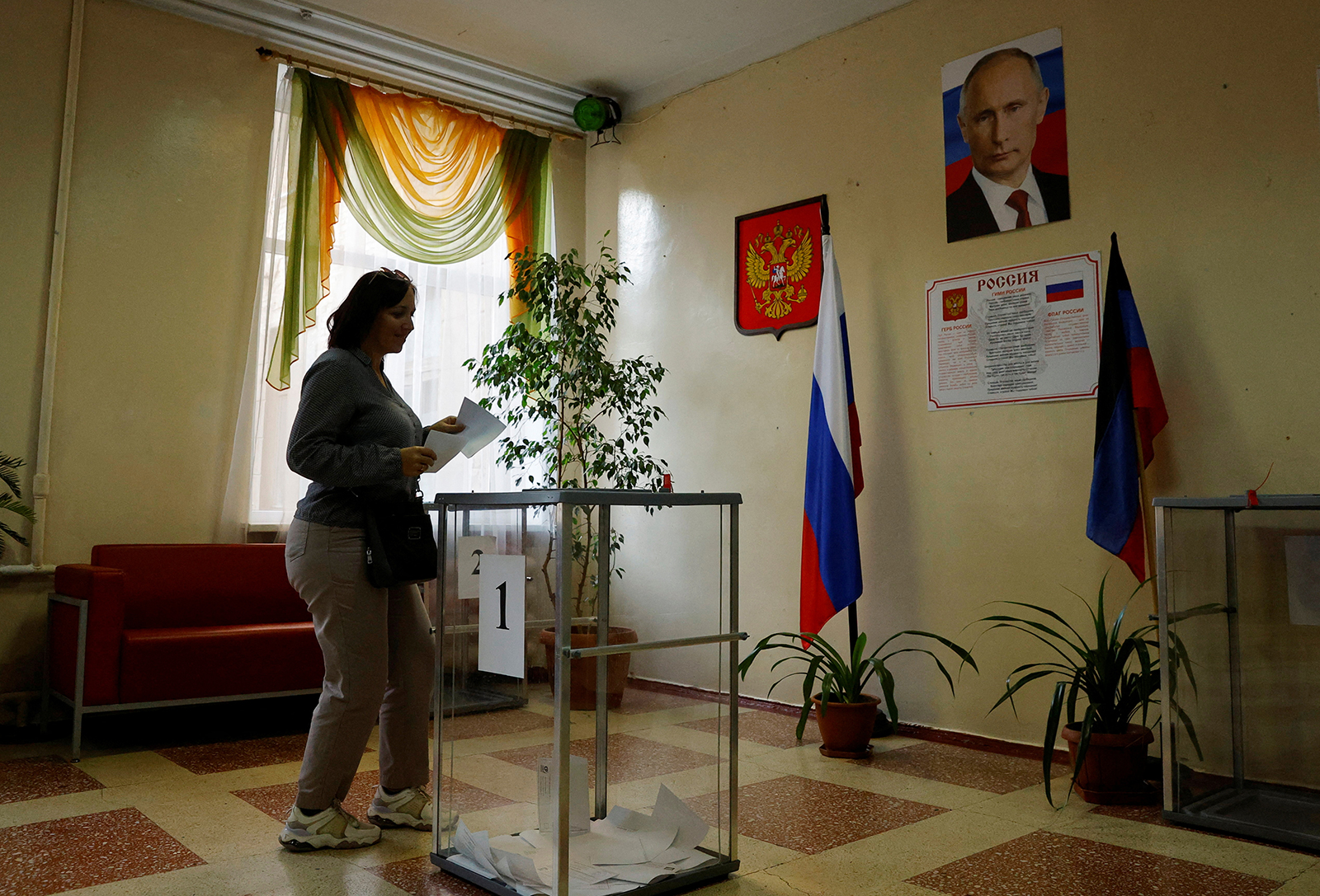 A voter casts her ballot at a polling station during local elections in Donetsk, Russian-controlled Ukraine, on September 9.