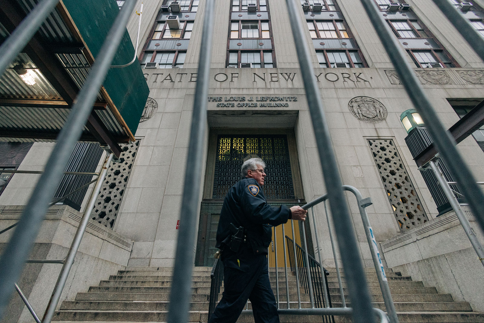 A New York police officer sets up a fence outside the Manhattan Criminal Court in New York on March 22.