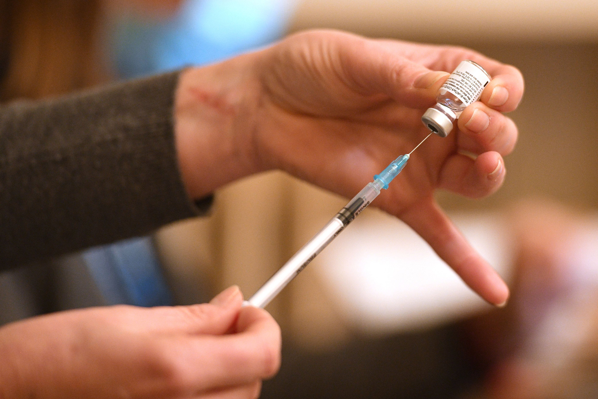 A healthcare professional draws up a dose of Pfizer/BioNTech Covid-19 vaccine at a vaccination center set up at Thornton Little Theatre in Thornton-Cleveleys, England, on January 29.