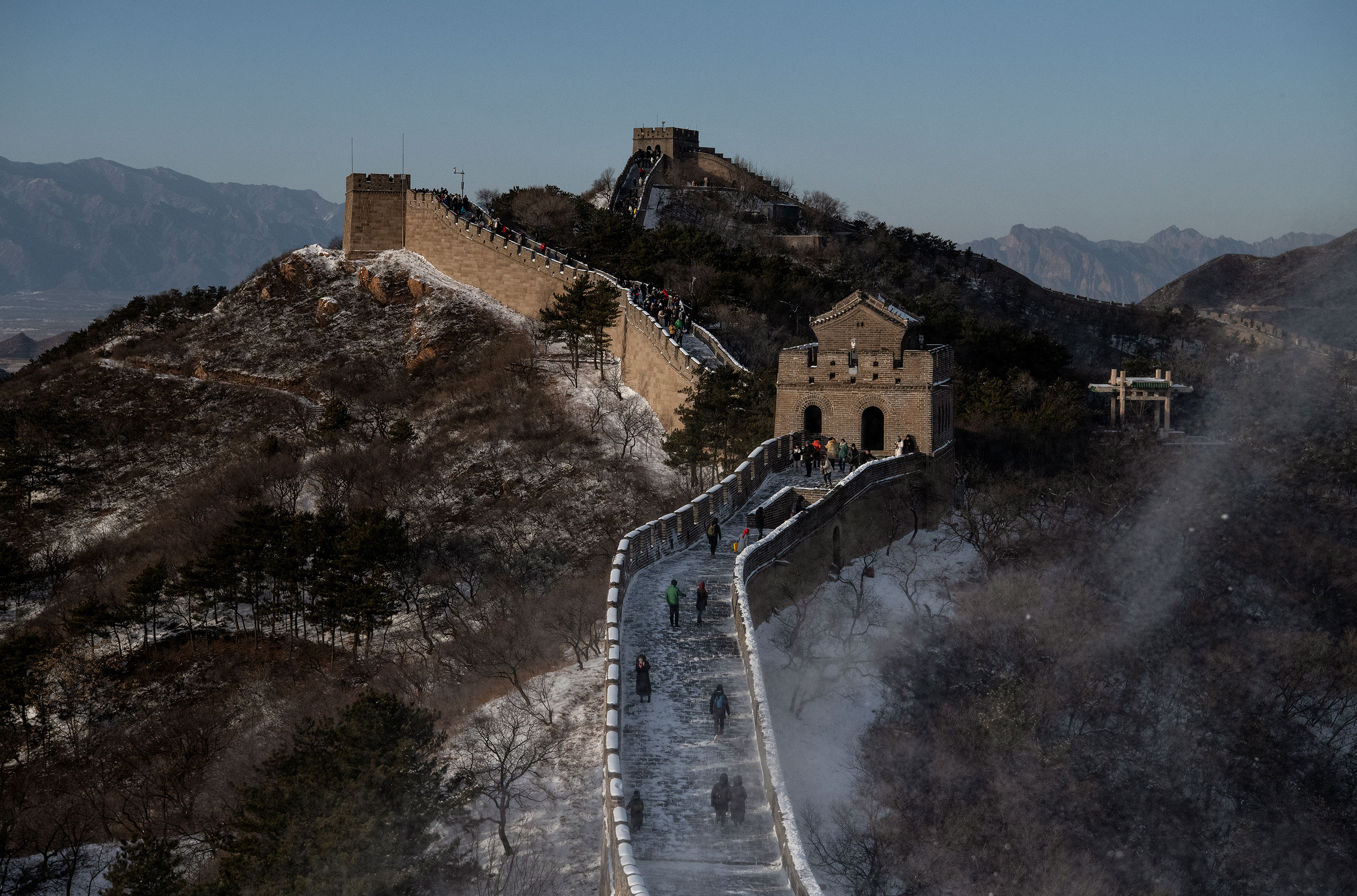 Tourists walk on a section of the Great Wall at Badaling, on November 30, 2019 in Beijing, China. 