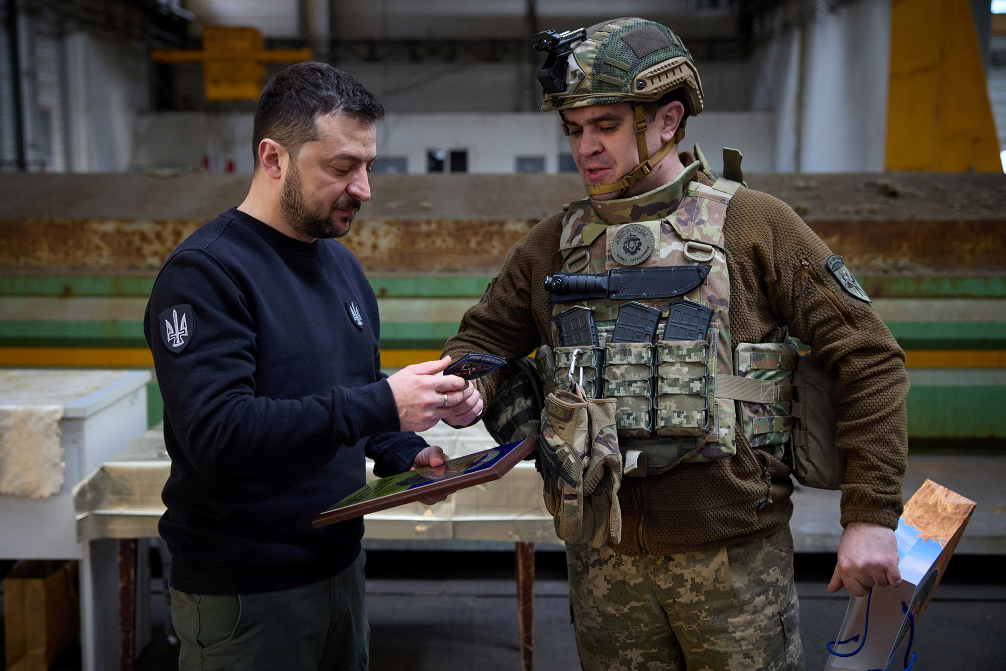 Ukraine's President Volodymyr Zelensky receives a military patch from a Ukrainian service member in Avdiivka, Donetsk region, Ukraine, on April 18.