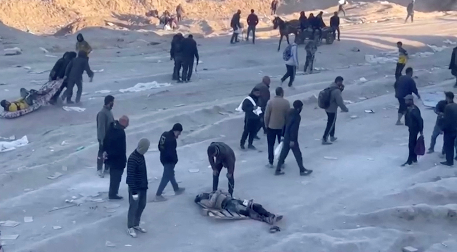 Palestinians transport casualties following what Palestinian health officials said was Israeli fire on people waiting for aid, in Gaza City, in this still picture taken from a video on February 29.