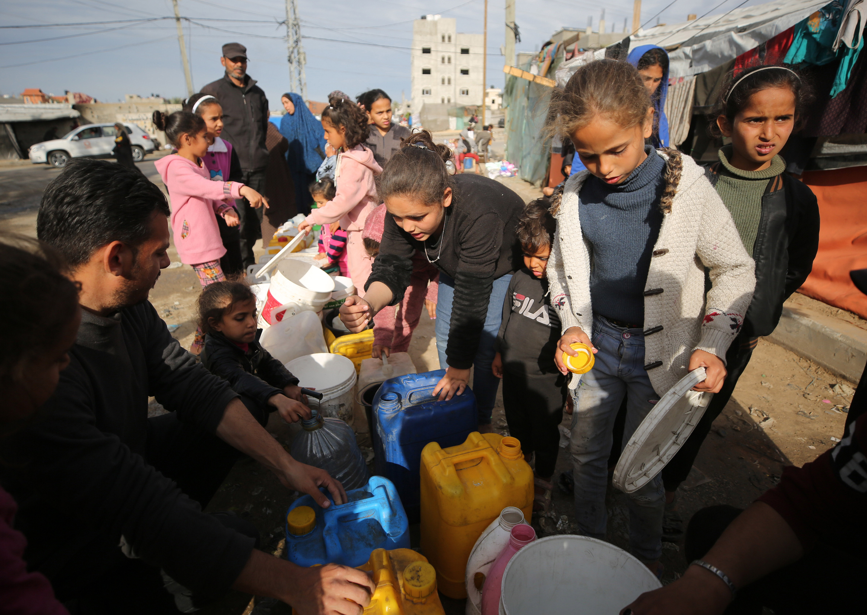 Children wait with bottles to get water in Rafah, Gaza on March 16.