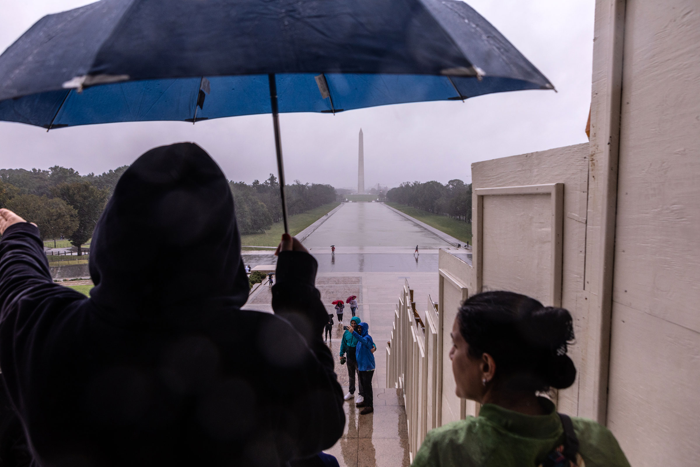 People walk through the rain on the steps of the Lincoln Memorial on September 23, 2023 in Washington, DC.