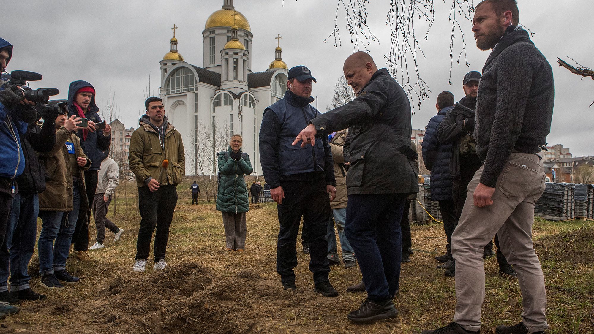 International Criminal Court (ICC) Prosecutor Karim Khan stands next to a grave where remains of three bodies were found, in the town of Bucha, Ukraine on April 13.